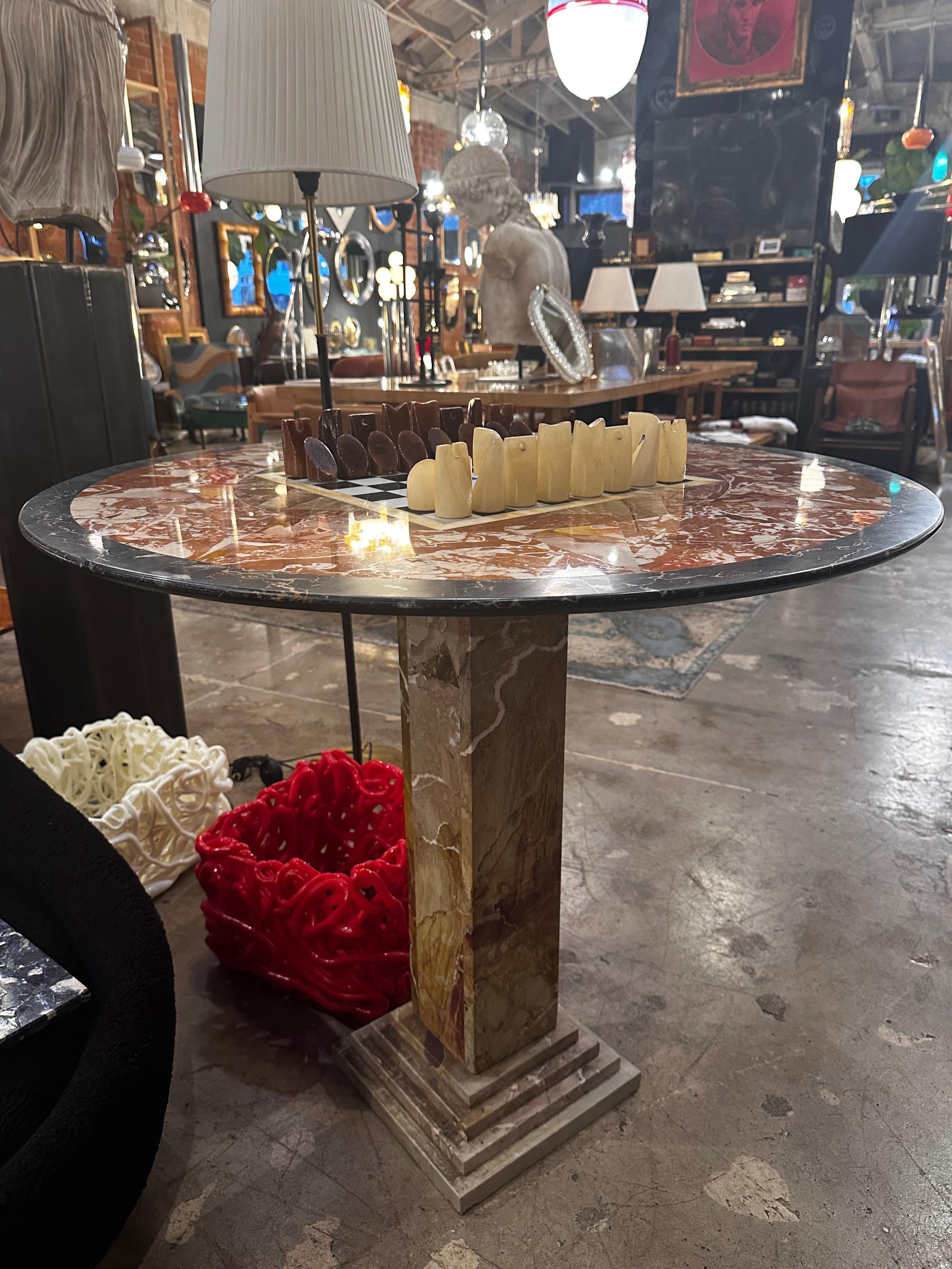 The Extraordinary Mid-Century Italian Green Marble Chess Table from the 1950s is a true work of art. Crafted from luxurious green marble, the table is a statement piece in itself. What sets it apart are the hand-carved marble chess pieces, adding an