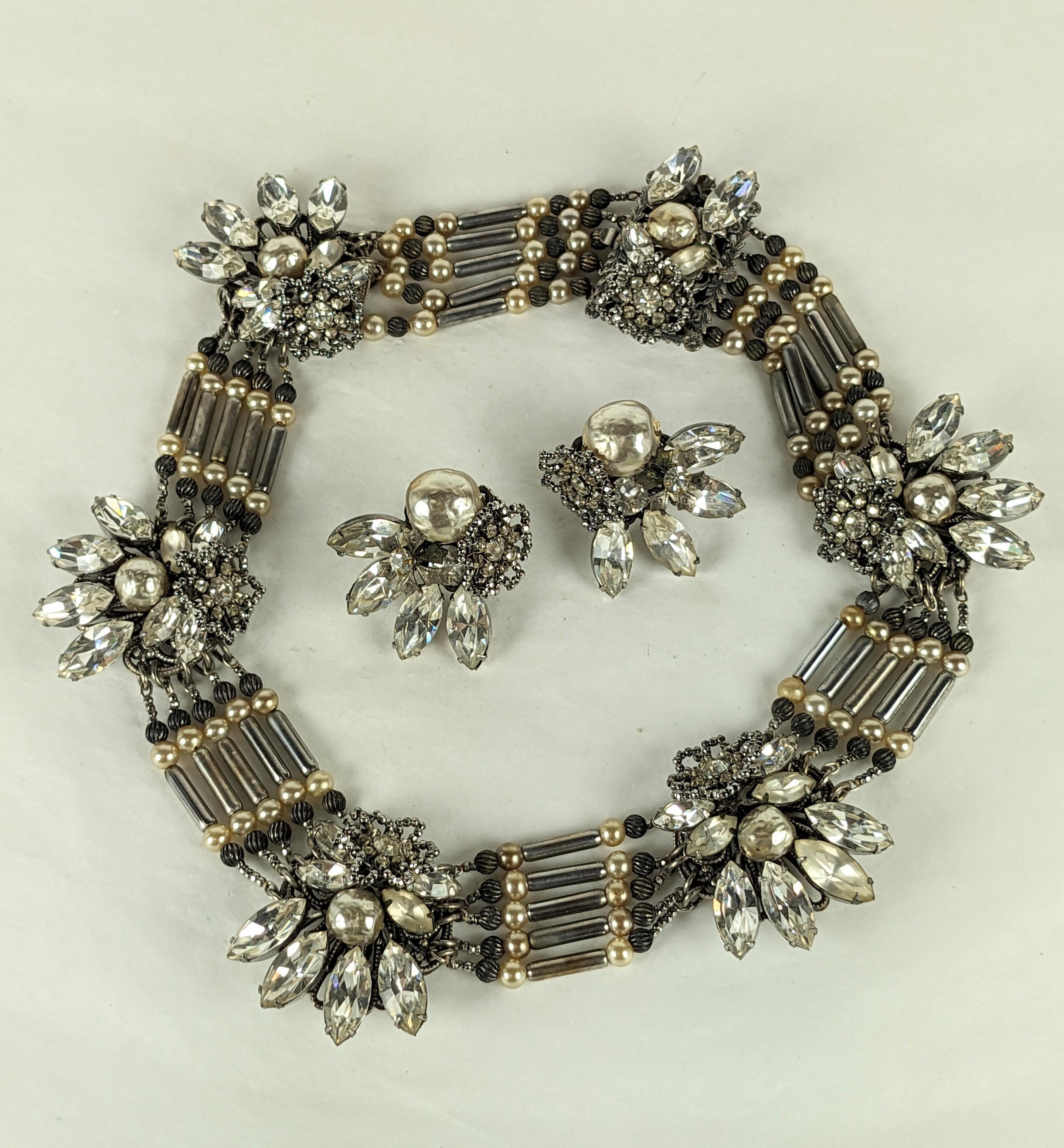Extraordinary Miriam Haskell Pearl and Cut Steel Collar Suite from the 1940's. Elaborate stations of faux pearls, marquise crystals and cut steel florets strung between silver toggle beads, faux pearls and cut steels. Matching clip earrings with