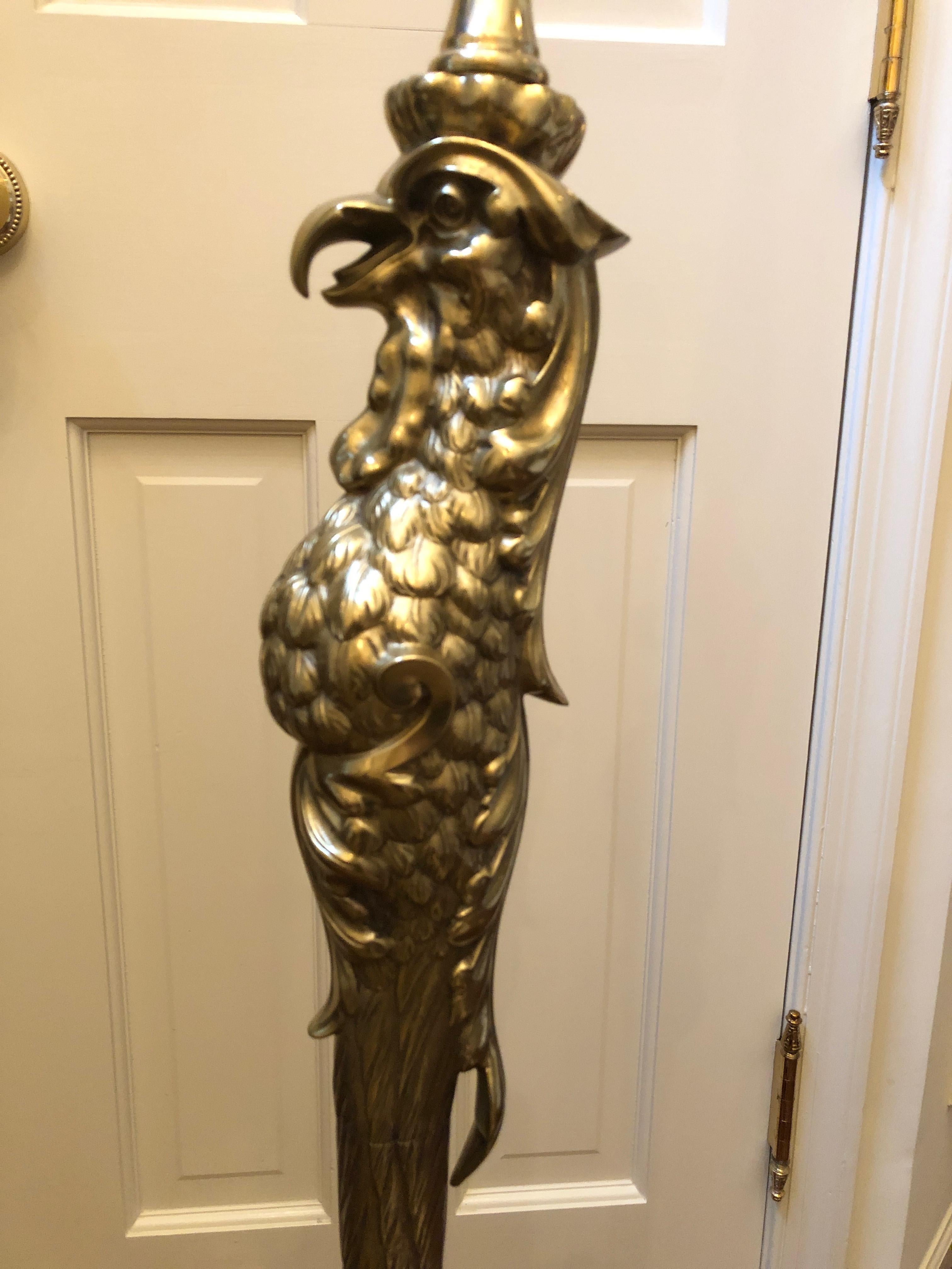 An incredible antique cast brass floor lamp by P. E. Guerin in the form of a stylized bird of prey having single elongated scaly leg and dramatic oversized claw foot with talons that form the base. Impressed on the upper rear talon is Patented April