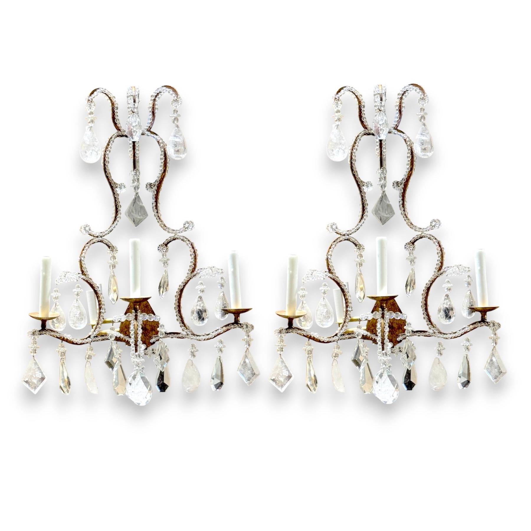 Extraordinary Pair Italian Neoclassical Rock Crystal Three-Light Wall Sconces 

Italy, 20th Century 

An extraordinary pair of Italian Neoclassical three-light wall sconces, exquisitely crafted in the 20th century, these stunning fixtures blend