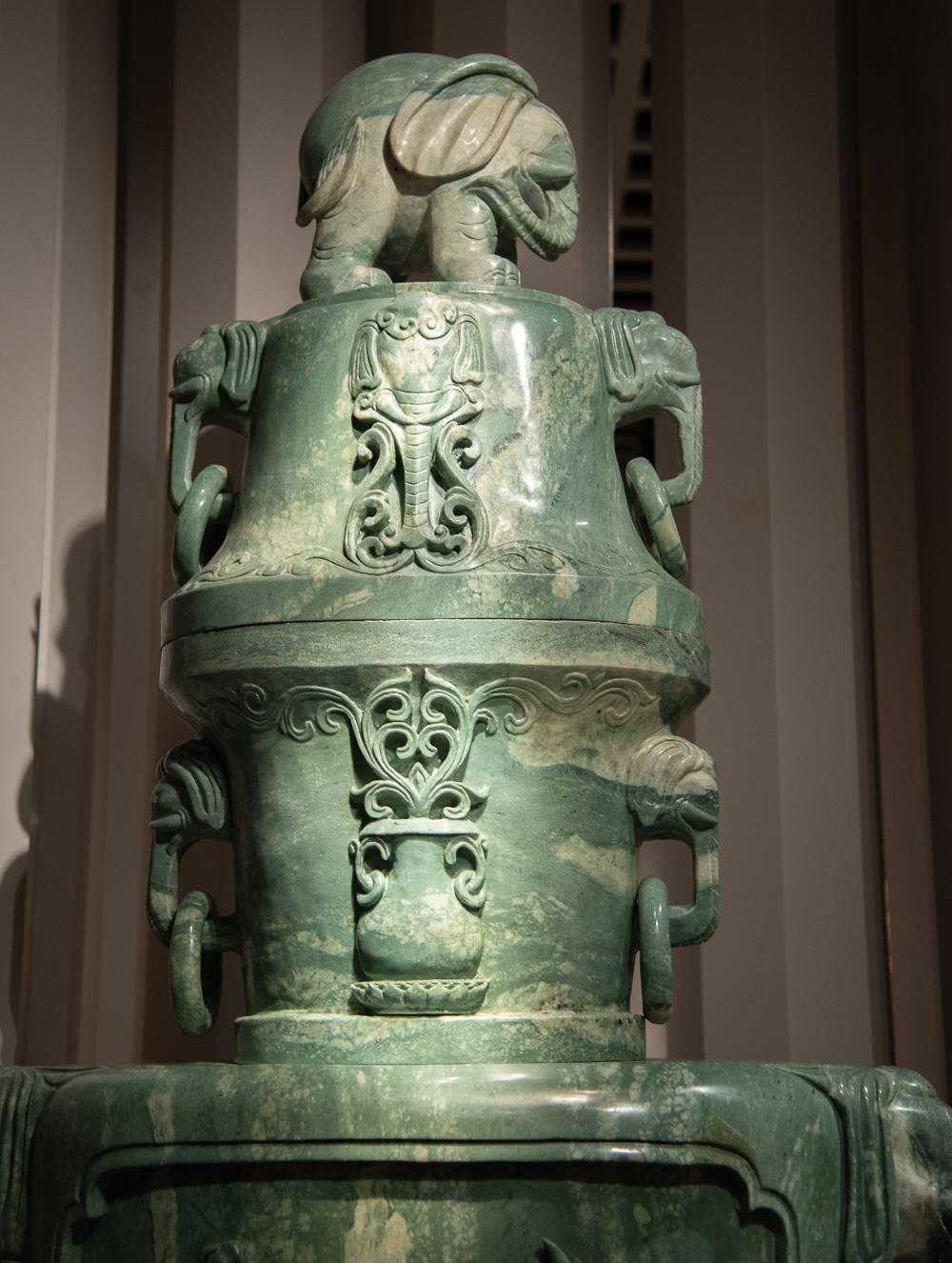 The vases are rendered in a quasi-archaic form; each executed in seven (7) separate sections carved from exceptionally large boulders of serpentine; the central sections featuring on one side shaped panels of a single Phoenix (the imperial emblem of