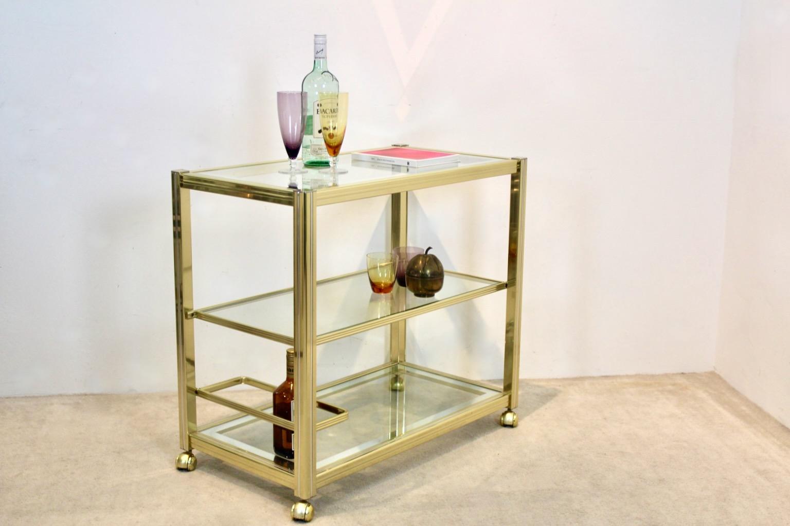 Extraoirdinary French Bar Cart in Brass with Chrome-Silver lining and Mirrored Glass. Designed and manufactured in France by Pierre Vandel in the ‘70s. The solid metal frame has a total original brass finish with elegant Chrome-Silver lining. The