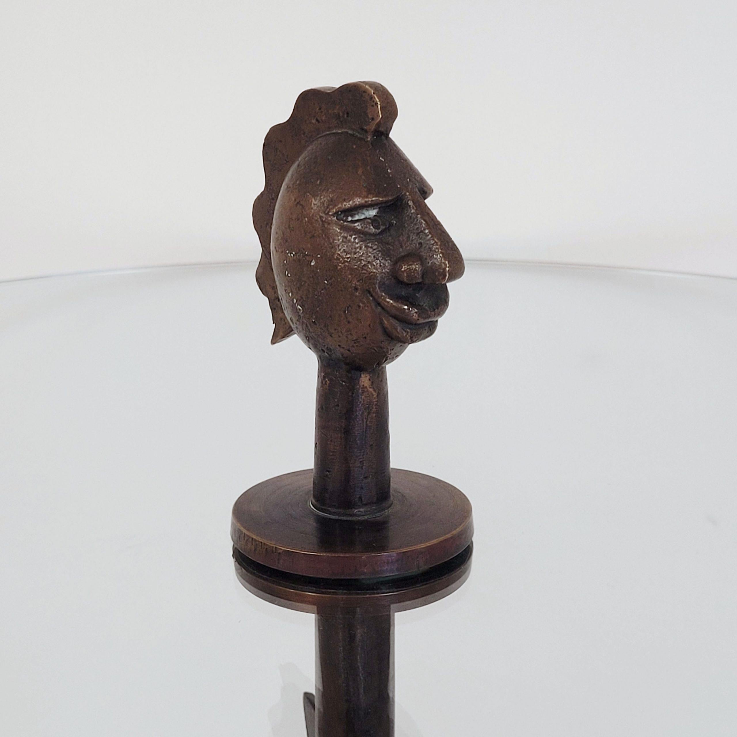 Rare round sidetable with bronze base and figurative end of an expressive head.
The table was made in Italy in the 60´s/ 70´s.
It is probably a unique piece, which was commissioned by the customer.
The bronze head is screwed on.
The glass top is