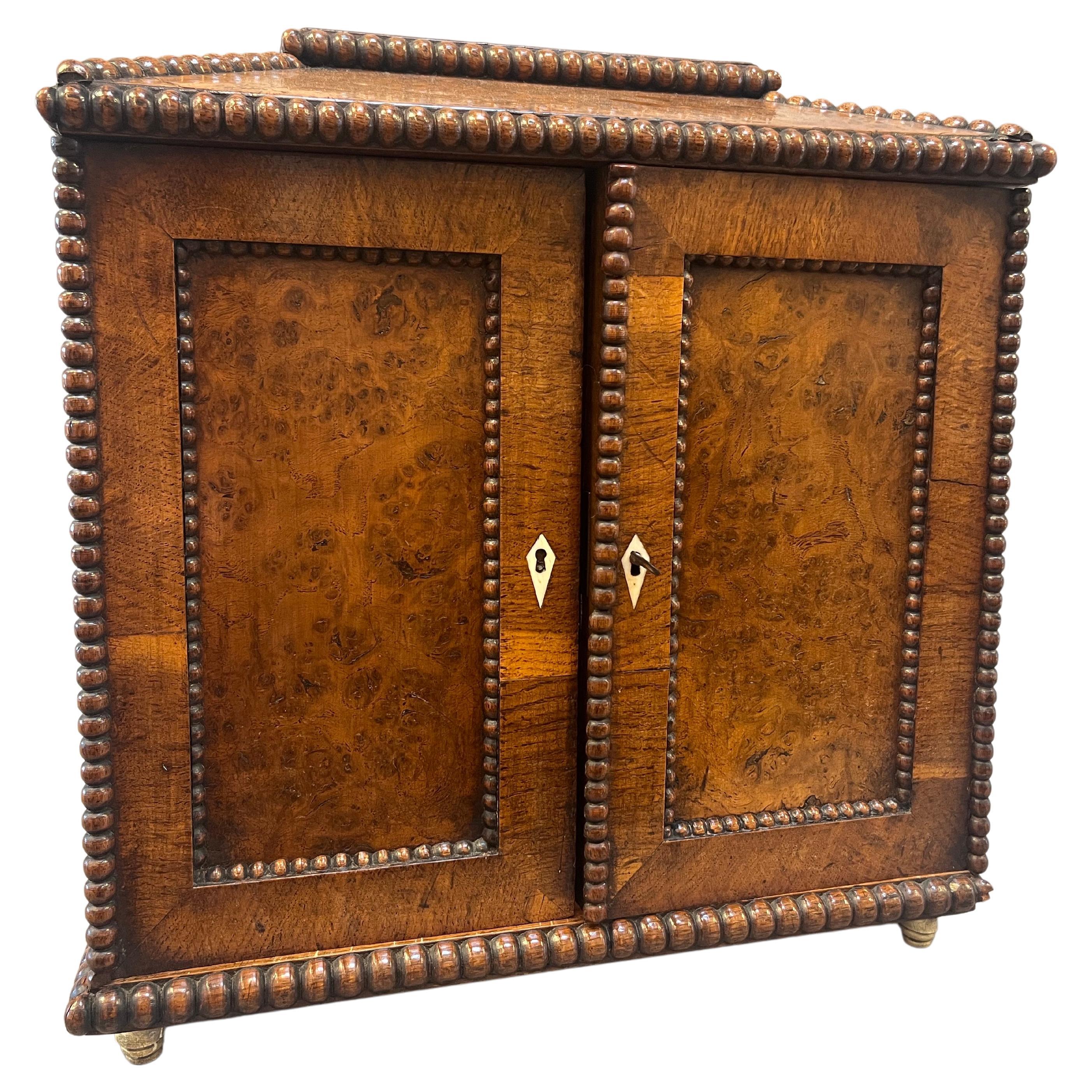  Extraordinary Regency Period English Silver Chest.  Burled “Pollard” Oak panels framed with delicate turned beaded mouldings and two burled doors concealing three burled drawers with bone handles, A paneled top conceals another compartment. In