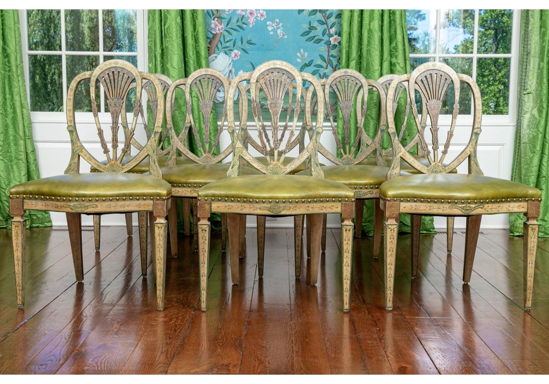 Superb Set of 8 George III style shield back side chairs with green faux leather seats, serpentine front, in a faux paint finish with hand painted foliate motifs, brass tack decoration with tapering front and gently splayed back legs.

Dimensions: