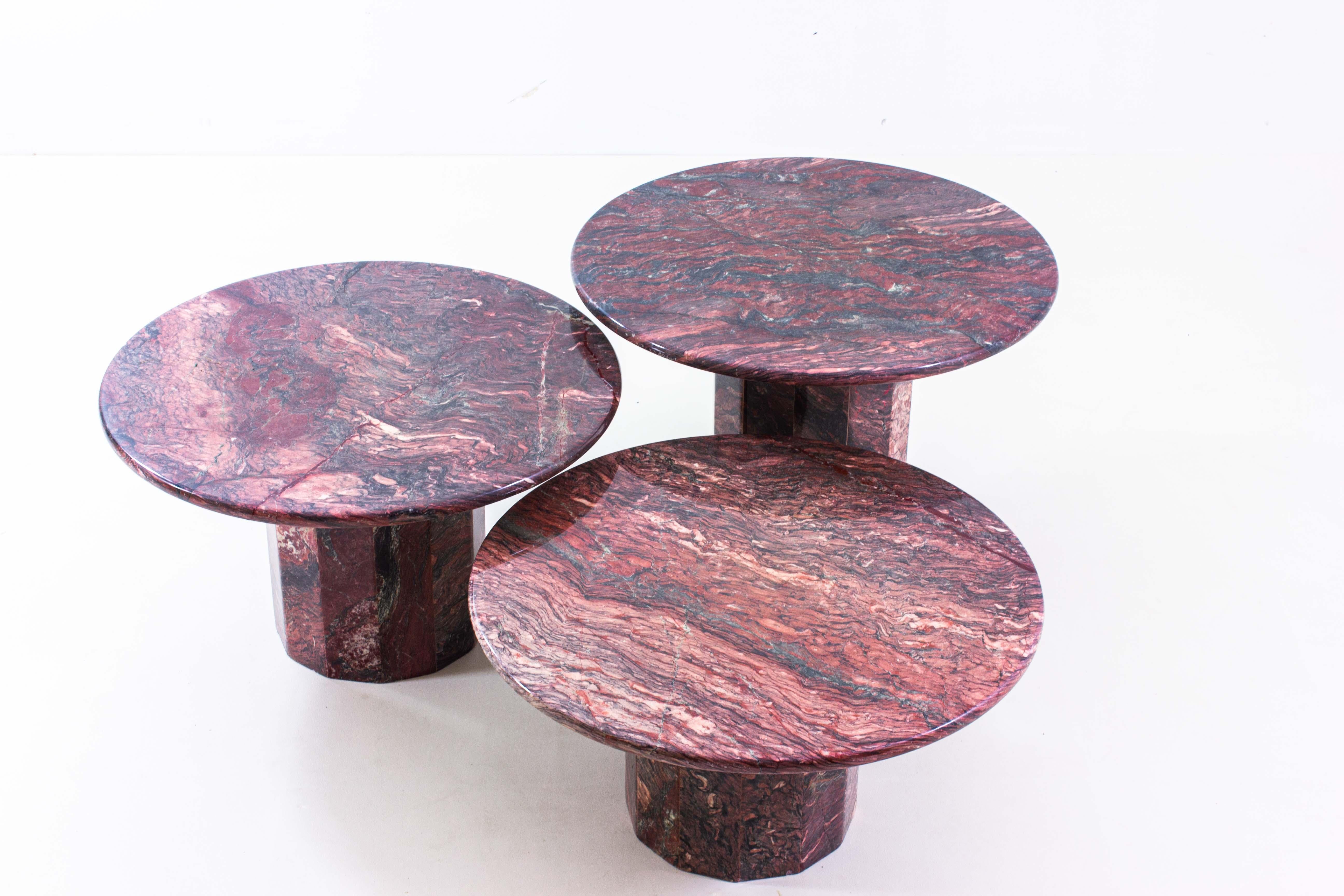 This hard to find set of 3 round coffee tables in burgundy wine red premium marble, comes in an exquisite condition.
The complex play of color within the table tops makes for a refined and elegant addition to any living room it will stand in.
