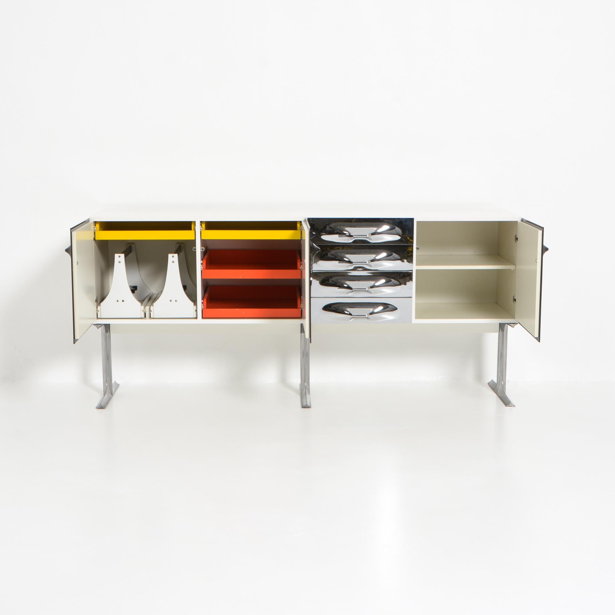 This exclusive and rare sideboard was designed by Raymond Loewy for Doubinsky Frères 2000 in France in the 1960s. This sideboard features 3 ABS plastic dark brown doors and 4 chromed ABS plastic drawers. The inside is very colorful with yellow and