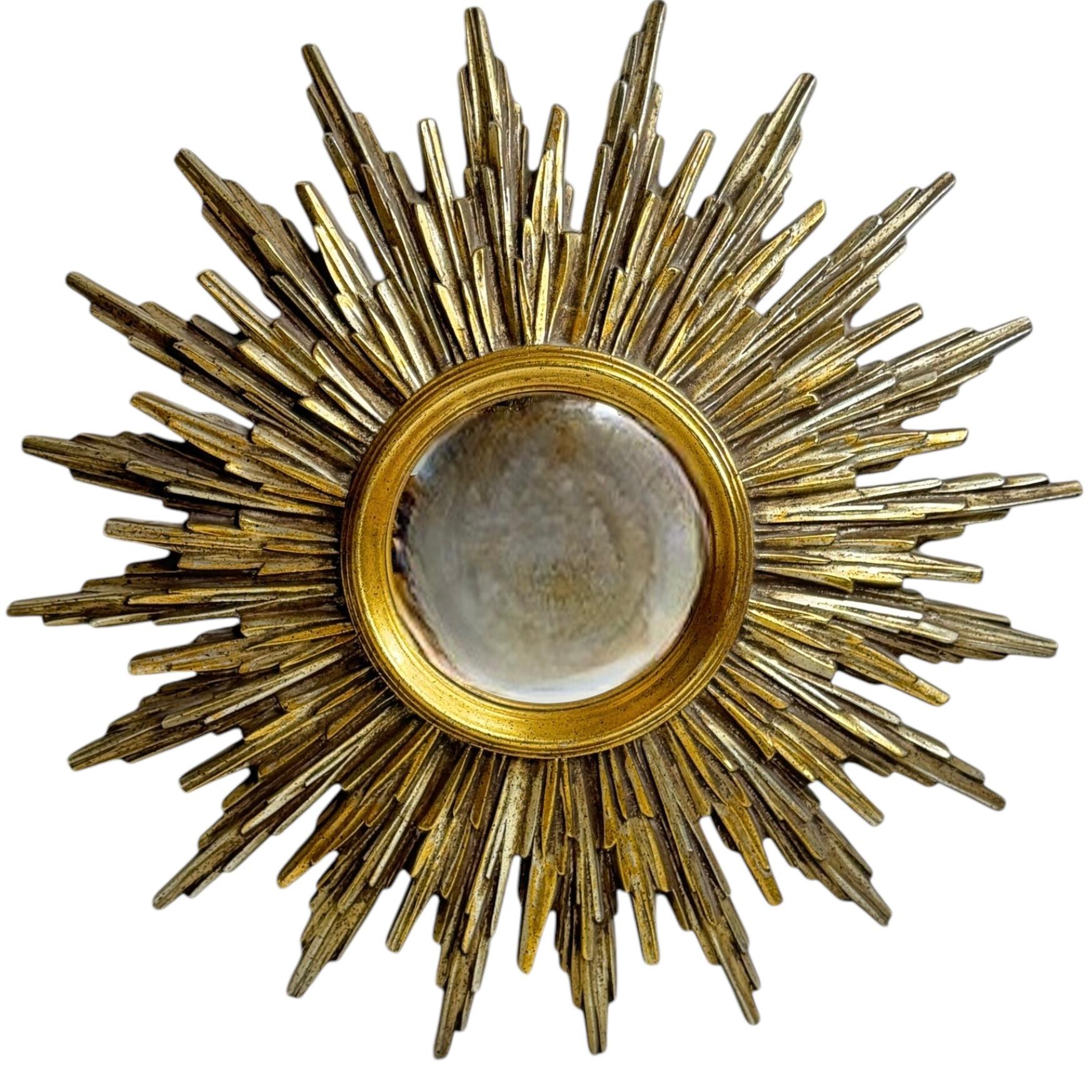 A gorgeous extraordinary Silver and gold starburst convex mirror. Made of silver and gilded resin. No chips, no cracks, no repairs. It measures approximate: 19.25