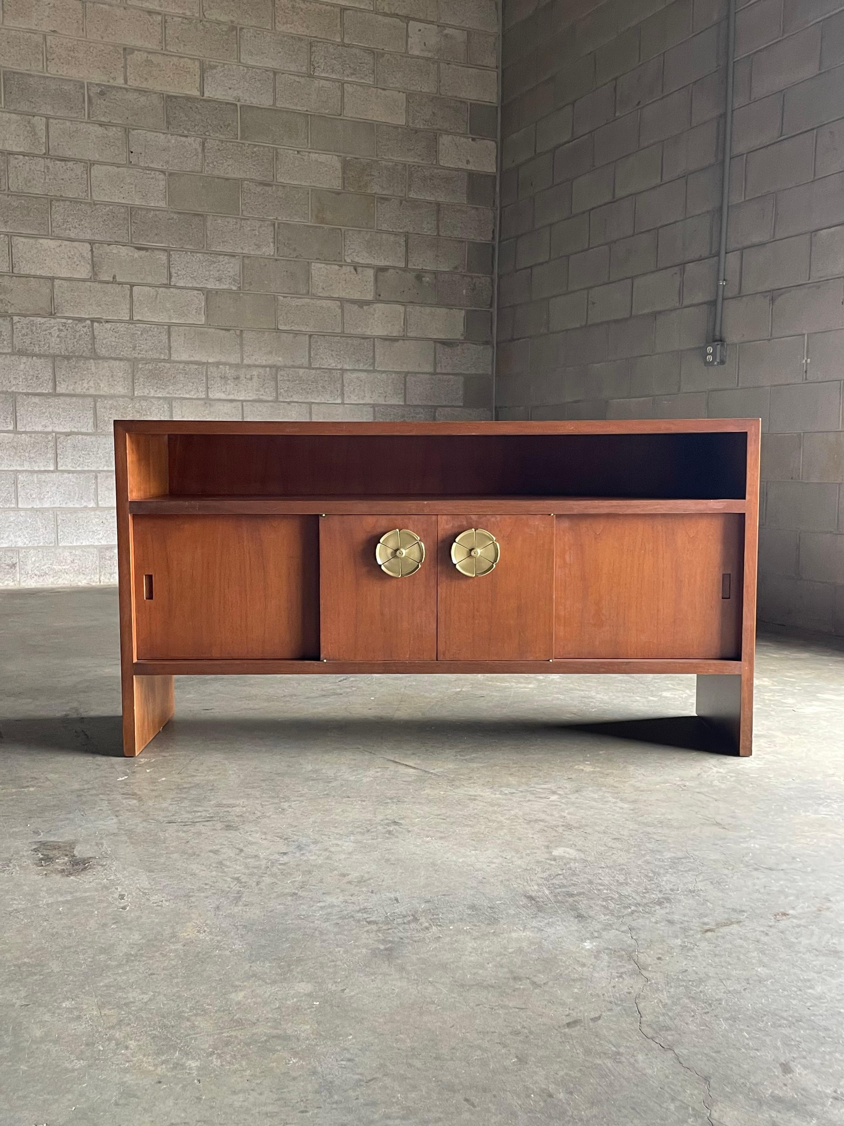 Rare sideboard by T.H. Robsjohn -Gibbings for Saridis of Athens. This piece is completely unique to the market, and one of only a few casegoods available for sale from this line. It's likely to never see another. 

Open shelf sits above sliding