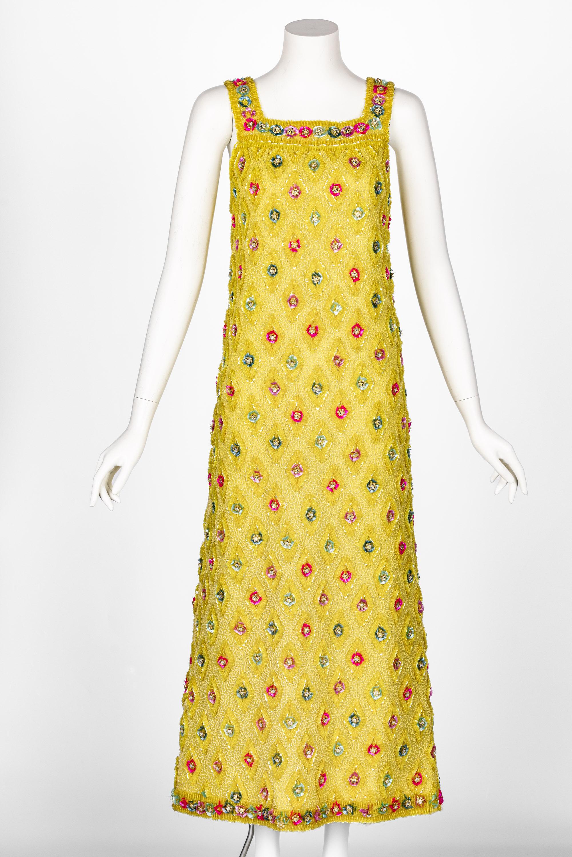 The beading on this 1960s dress is a true highlight of its design, showcasing meticulous craftsmanship. Each bead is carefully hand-sewn onto the fabric, forming a pattern of raised diamond shapes that give the dress a textured, almost