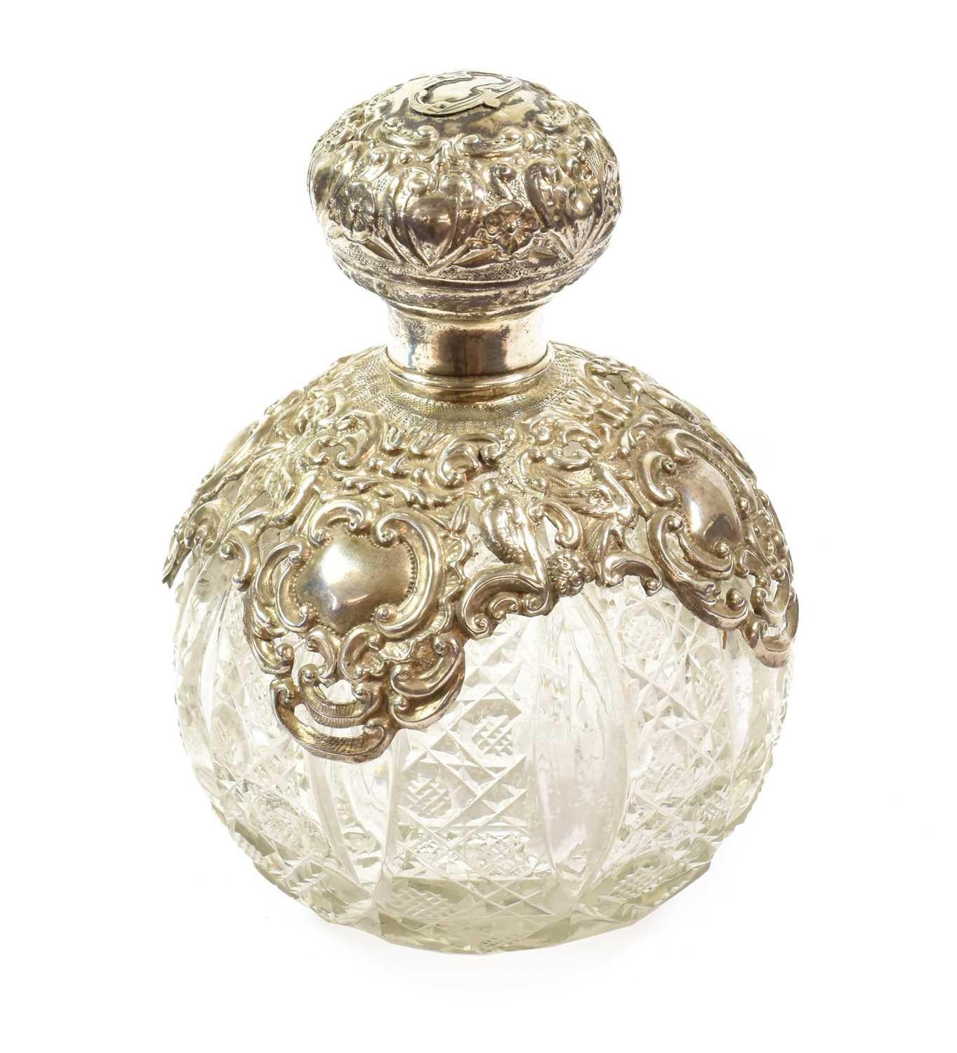 Extraordinary Rare Silver Metal Mounted Cut Glass Scent Bottle on a Victorian Silver Stand by George Edward & Sons

An impressive representation of finer living during the Edwardian or Victorian era with silver metal-mounted cut glass embellishments
