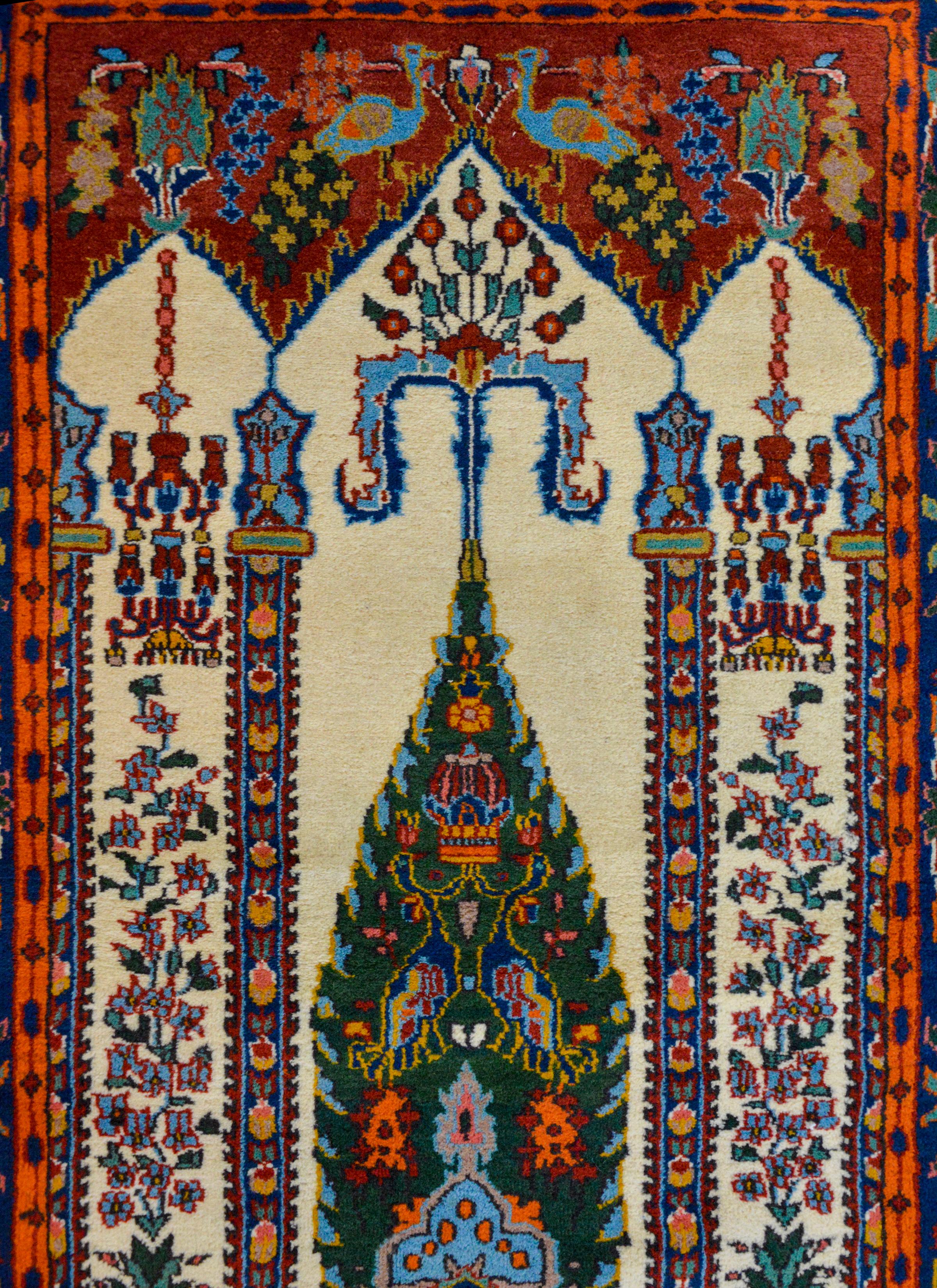 An extraordinary vintage Indian Bakhtiari Style prayer rug depicting myriad potted flowers and trees, and birds inside an architectural interior with hanging chandeliers. The border is wonderfully expressive with more flowers and birds flanked by a