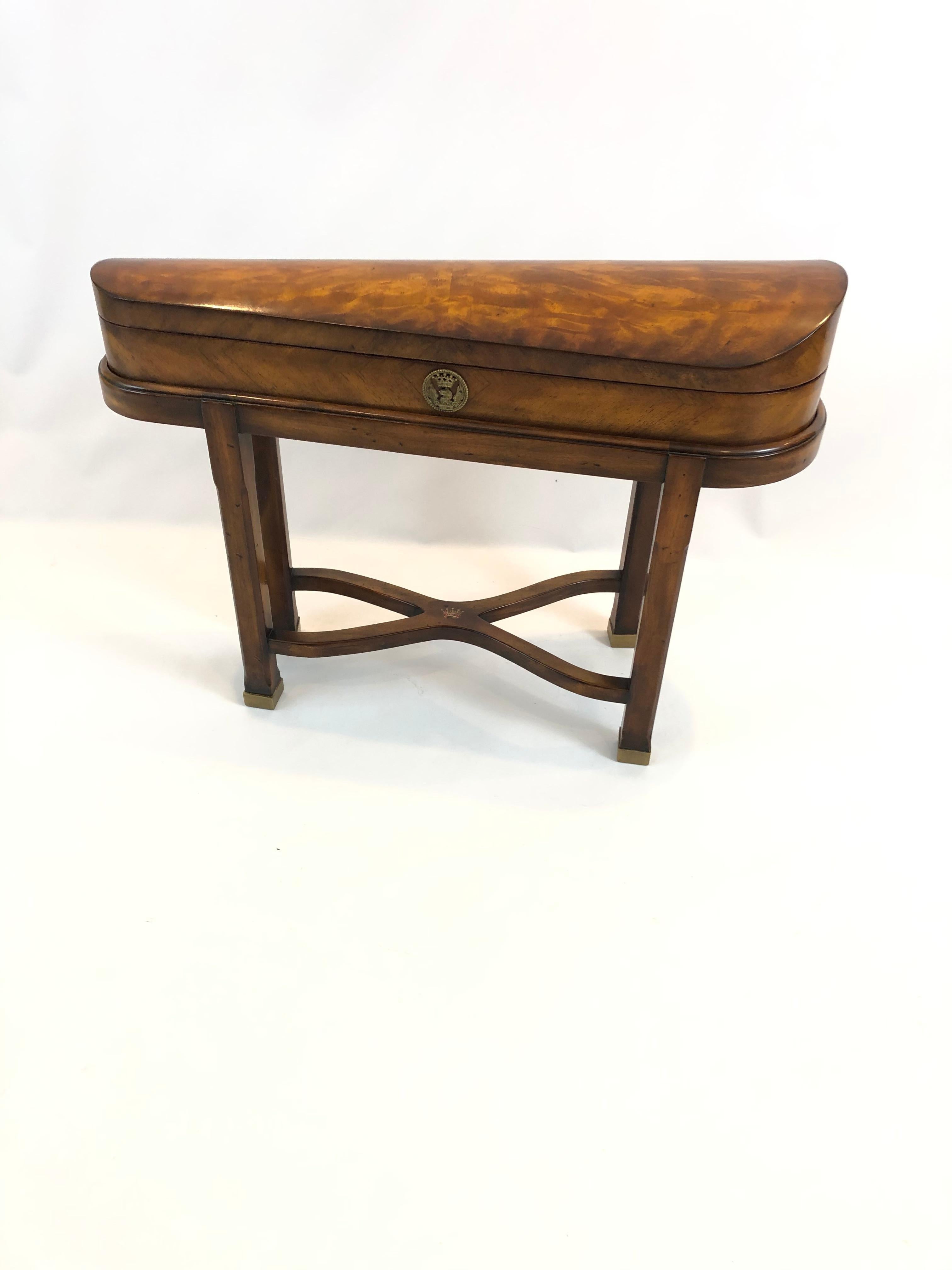 A magical conversation piece of an end table from the Althorp Edition of Theodore Alexander, having gorgeous grained burl violin case shaped form. The table top opens to reveal a hollowed out violin shape and 3 little drawers with brass violin