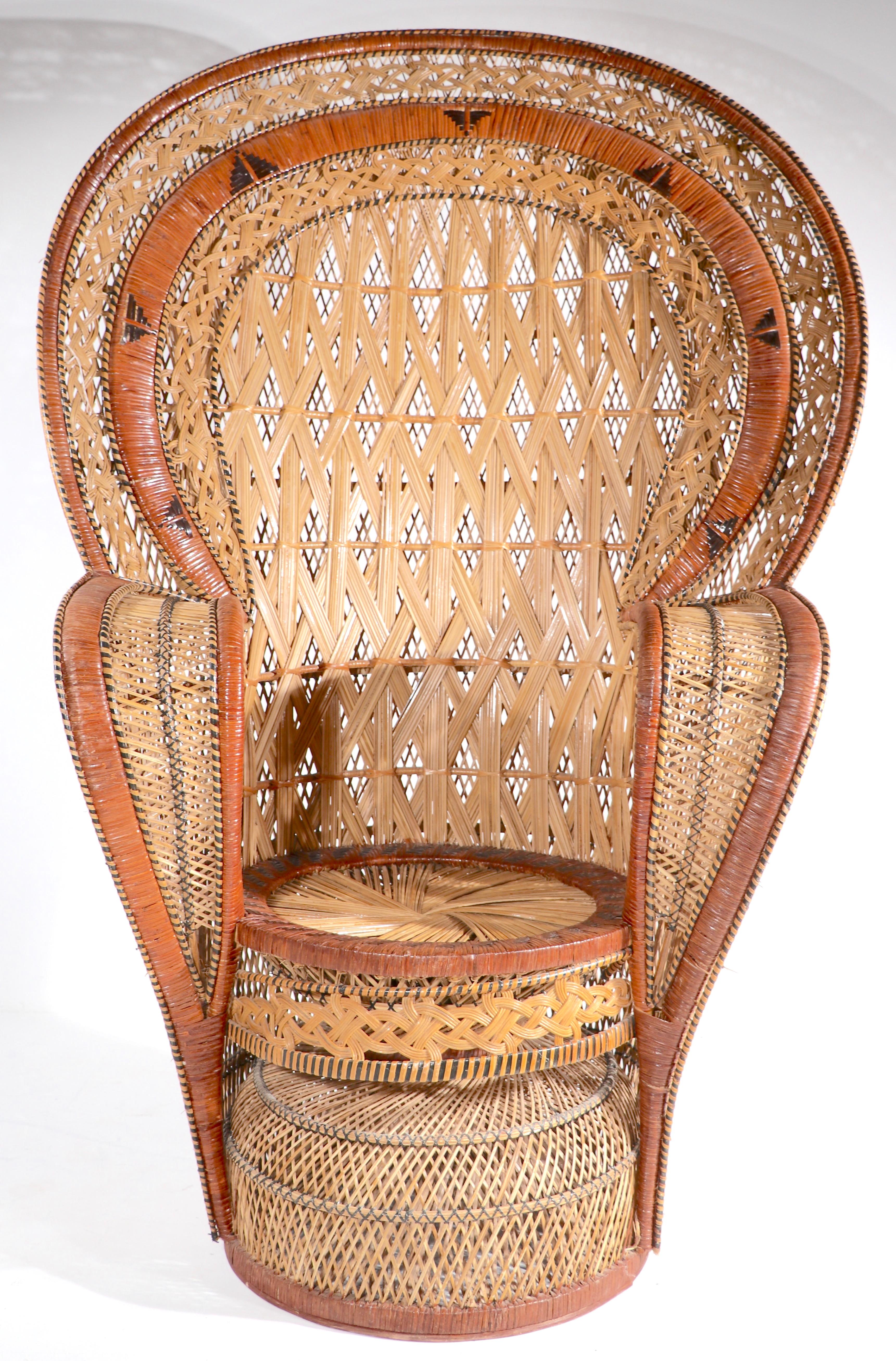 Exceptional wicker peacock chair, having an unusually intricately woven wicker body, in very good original condition. Iconic form, sometimes referred to as the Emanuelle chair, imported from Asia, circa 1970's. 
 Measures: Total H 65 X arm H 34.5 x