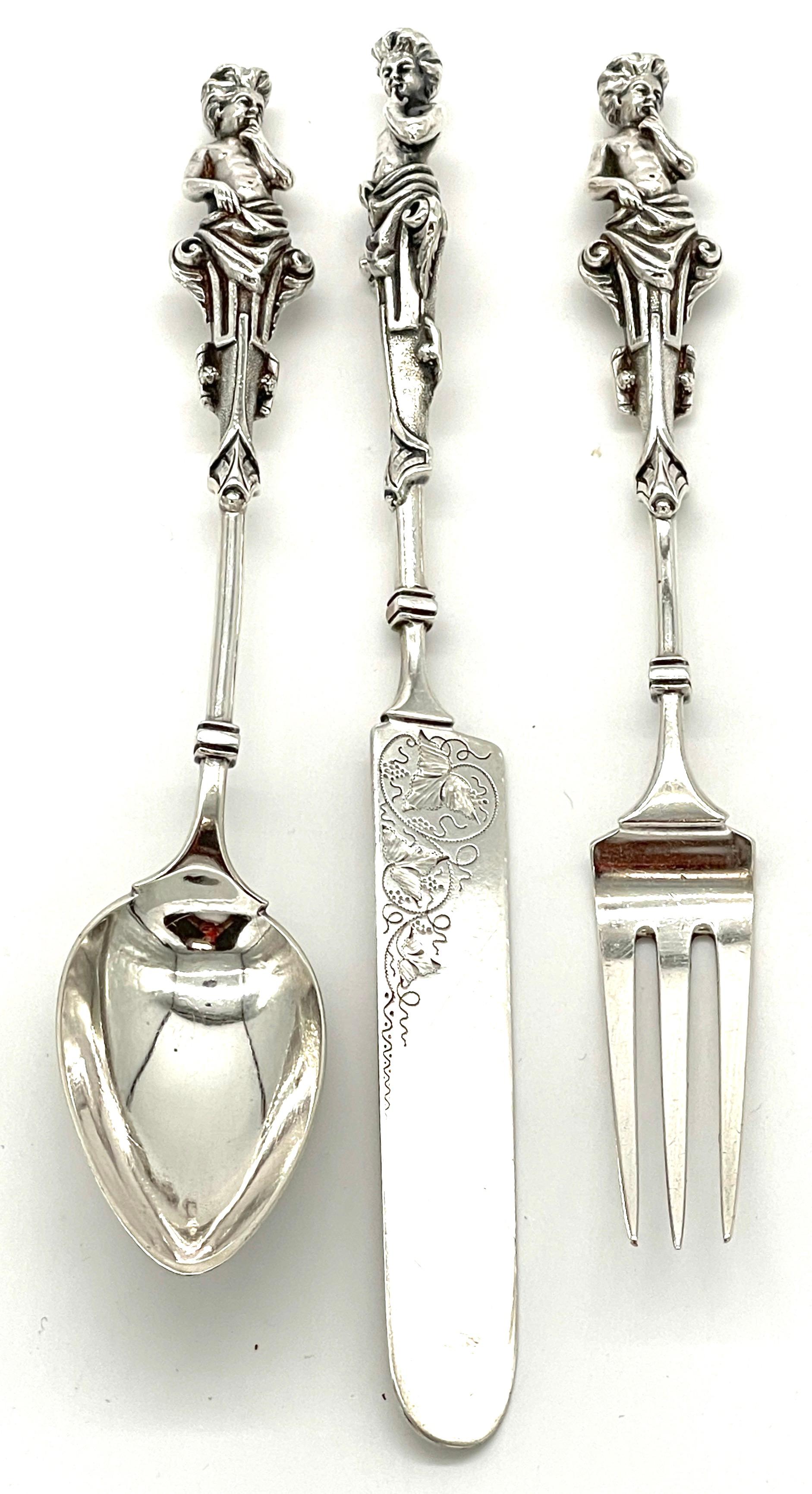 Extraordinary Wood & Hughes Figural Sterling Three-Piece Baby/ Youth Set 
Wood and Hughs, NY NY (1871-1899)

A fine Wood & Hughes figural sterling three-piece baby/ youth set,  made by the renowned Wood and Hughes silversmiths of New York City, from