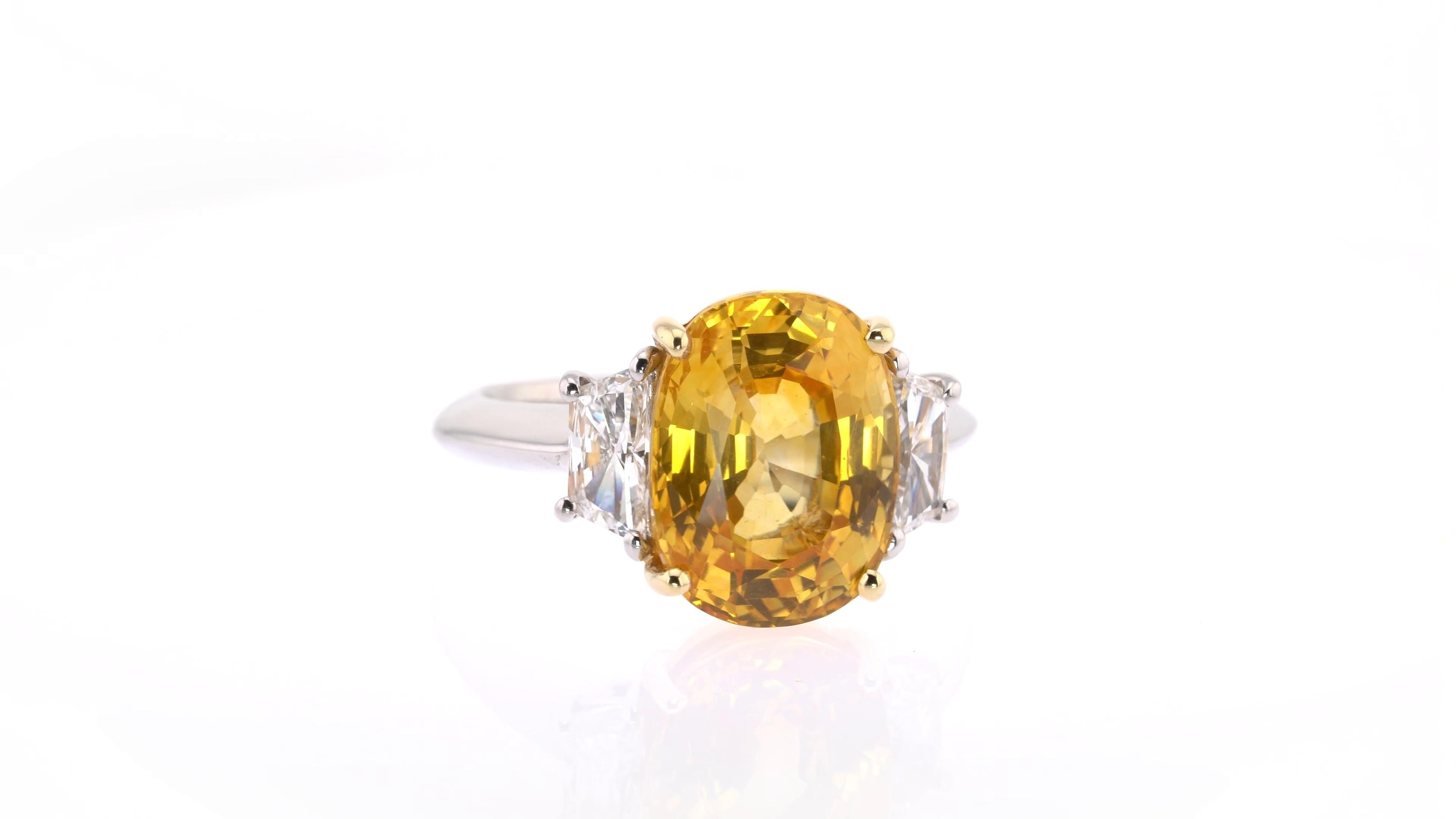 This astonishing yellow sapphire at the centre of this three-stone ring was hand-picked from the Tiffany vault and is truly one of a kind. Weighing more than eight carats and featured in a bold oval shape, it is shouldered by two trapezium white