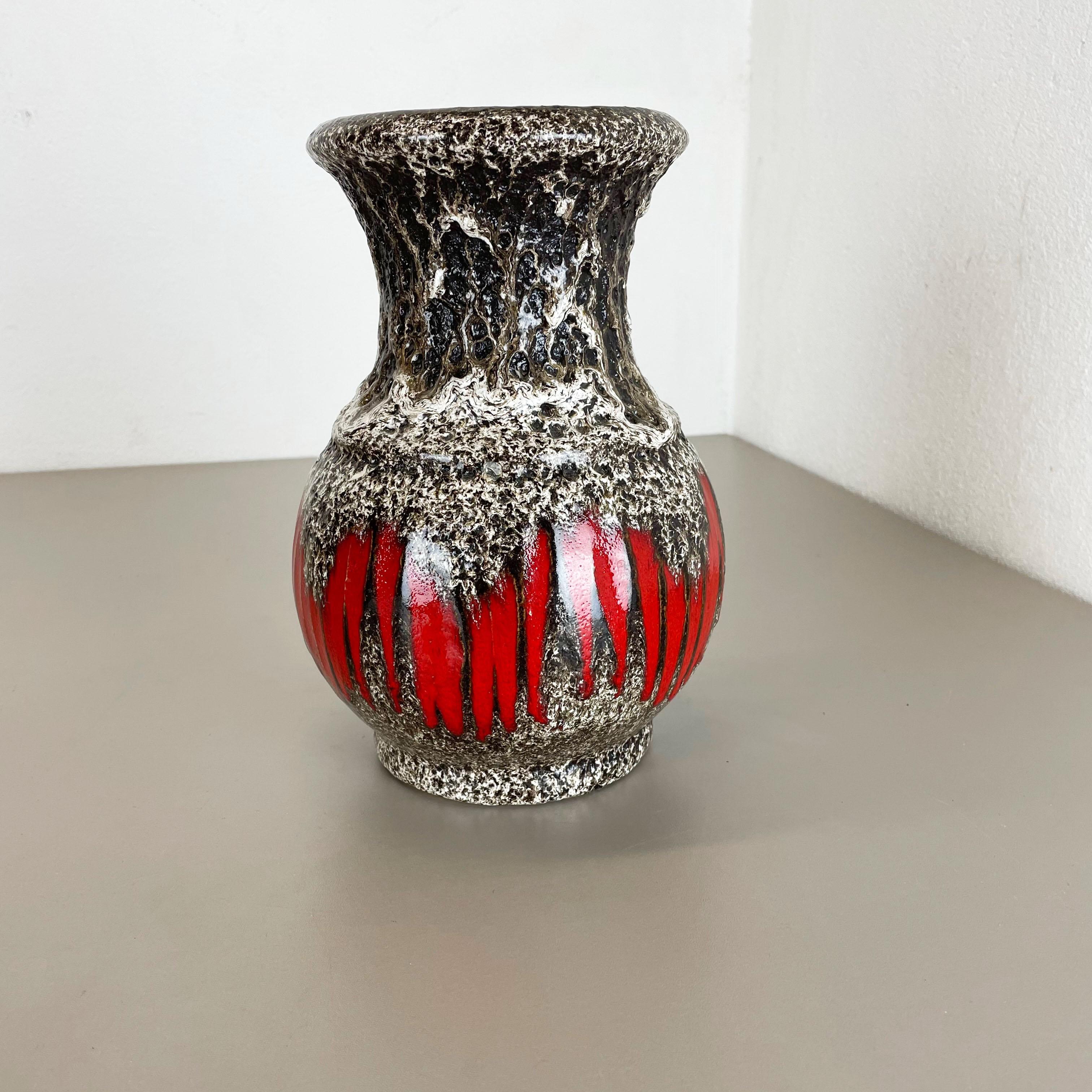 Article:

Fat lava art vase super rare black white red



Producer:

Scheurich, Germany



Decade:

1970s




This original vintage vase was produced in the 1970s in Germany by Scheurich. It is made of ceramic pottery in fat lava