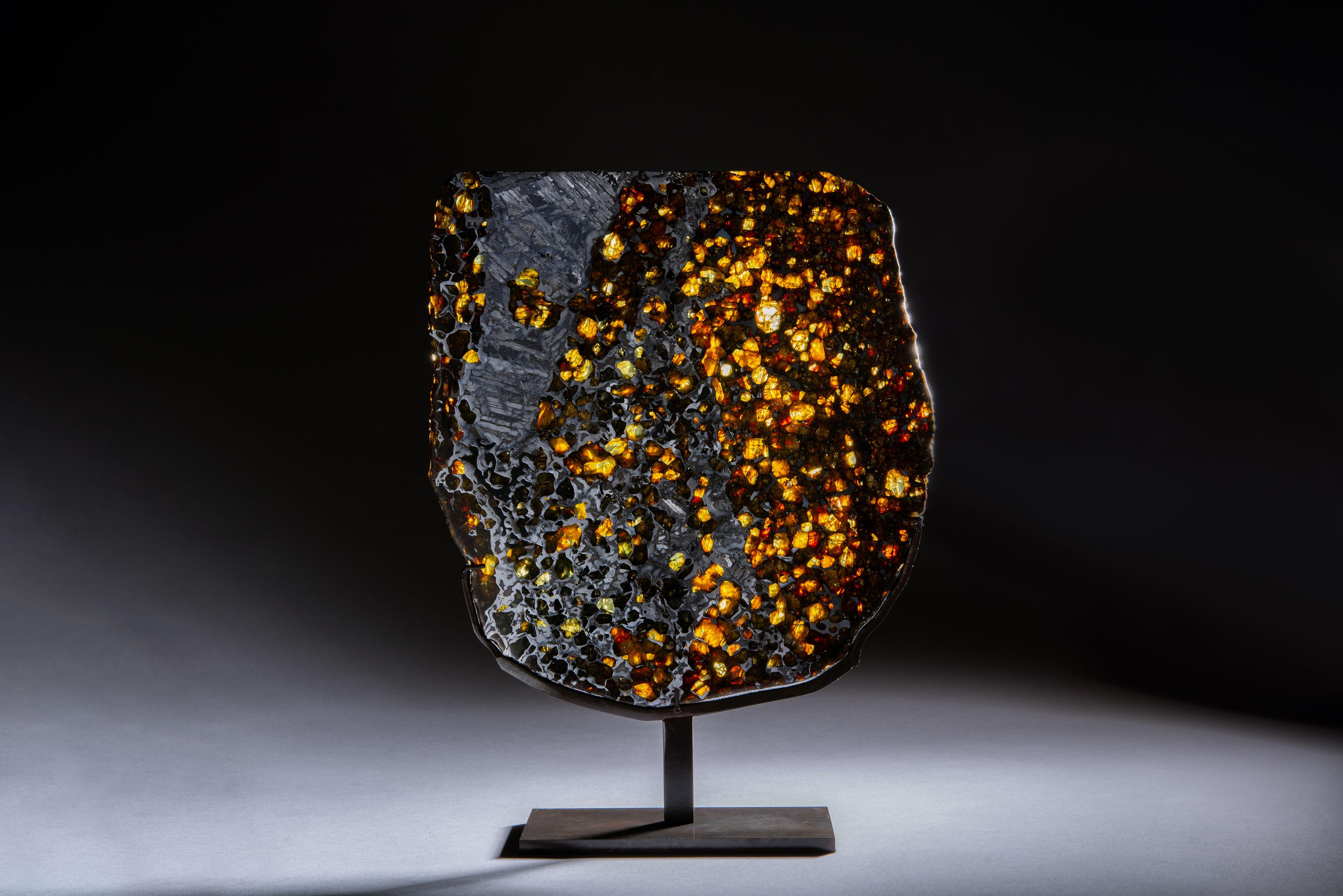 A cross section cut from an extremely rare pallasite Meteorite, recovered from the Hekandue river bed, Seymchan, Far East Russia.

Created during the formation of our solar system, some 4.55 billion years ago, pallasites are the most beautiful