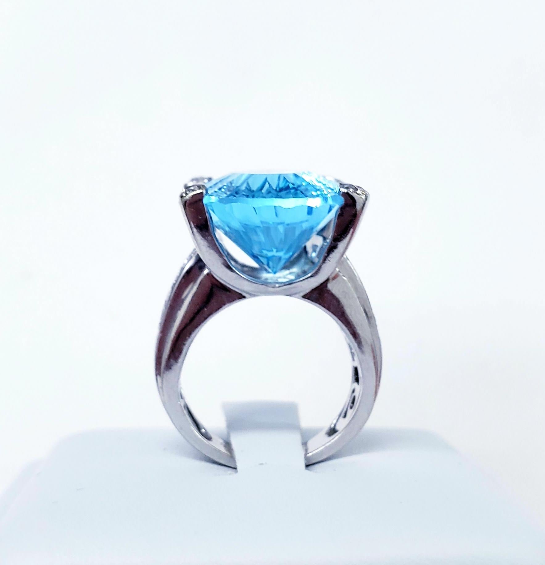 Modern Bold cocktail ring featuring a massive 20mm X 15mm (Approx 17 carats) oval Blue Topaz gemstone and 0.50tcw in round diamonds hand crafted in 18k white gold. 
Size 5
Circa 2000s 

