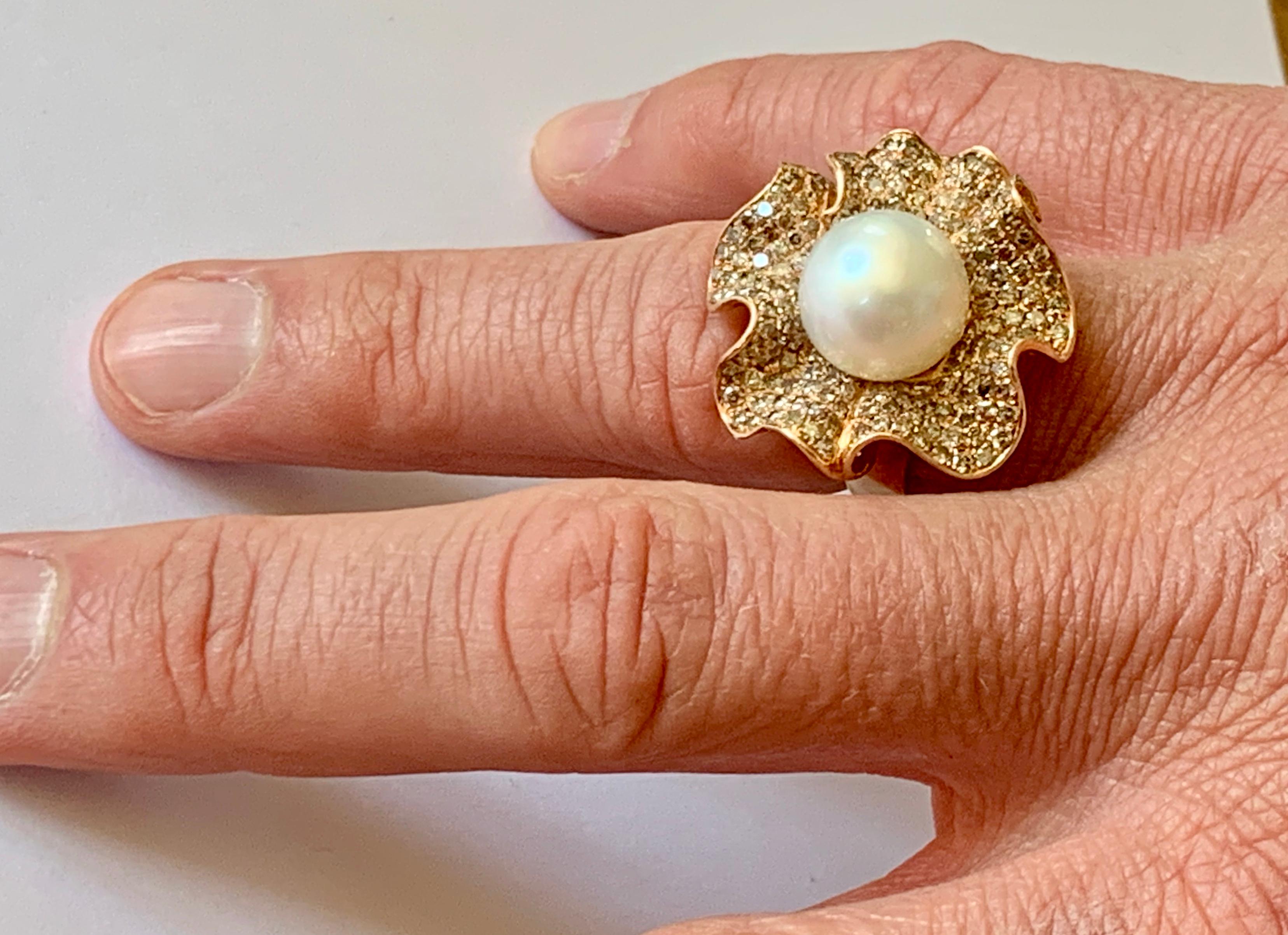 18 K Rose Gold Ring with Champagne colored Diamonds and South Sea Pearl. 
Set with 170 brownish Diamonds weighing 2.50 ct and one white South Sea Pearl measuring approximately 12 mm. 
The ring is currently size 55/15 but can be resized larger or