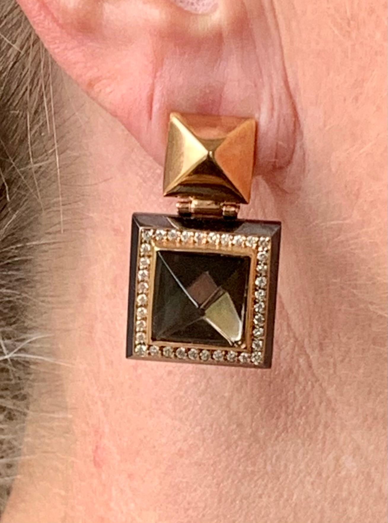Extravagant modern and bold earrings with a cool elegance. The 2 pyramid shaped Smoky Quartz surrounded by Diamonds with a total weight of 0.58 ct are set on a Hematite back. Very unusual and definitively for the very discenerd woman. The earrings