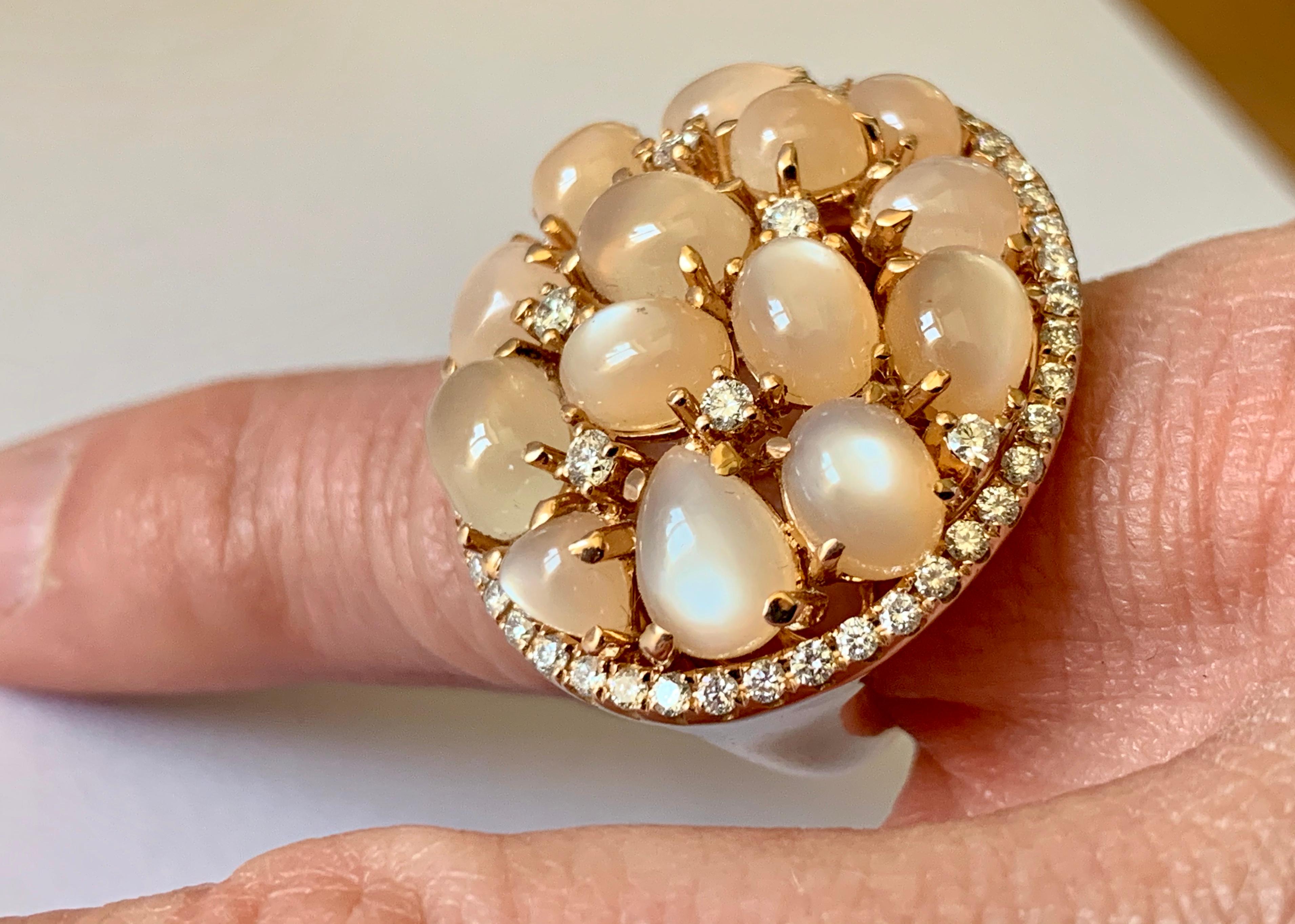 Unusual 18 K Rose Gold Ring set with 14 brownish labardorescent Moonstones weighing 13.02 ct and further decorated with 52  brilliant cut Diamonds weighing 0.94 ct. 
The ring is currently size 54/14 but can be resized larger or smaller if necessary.
