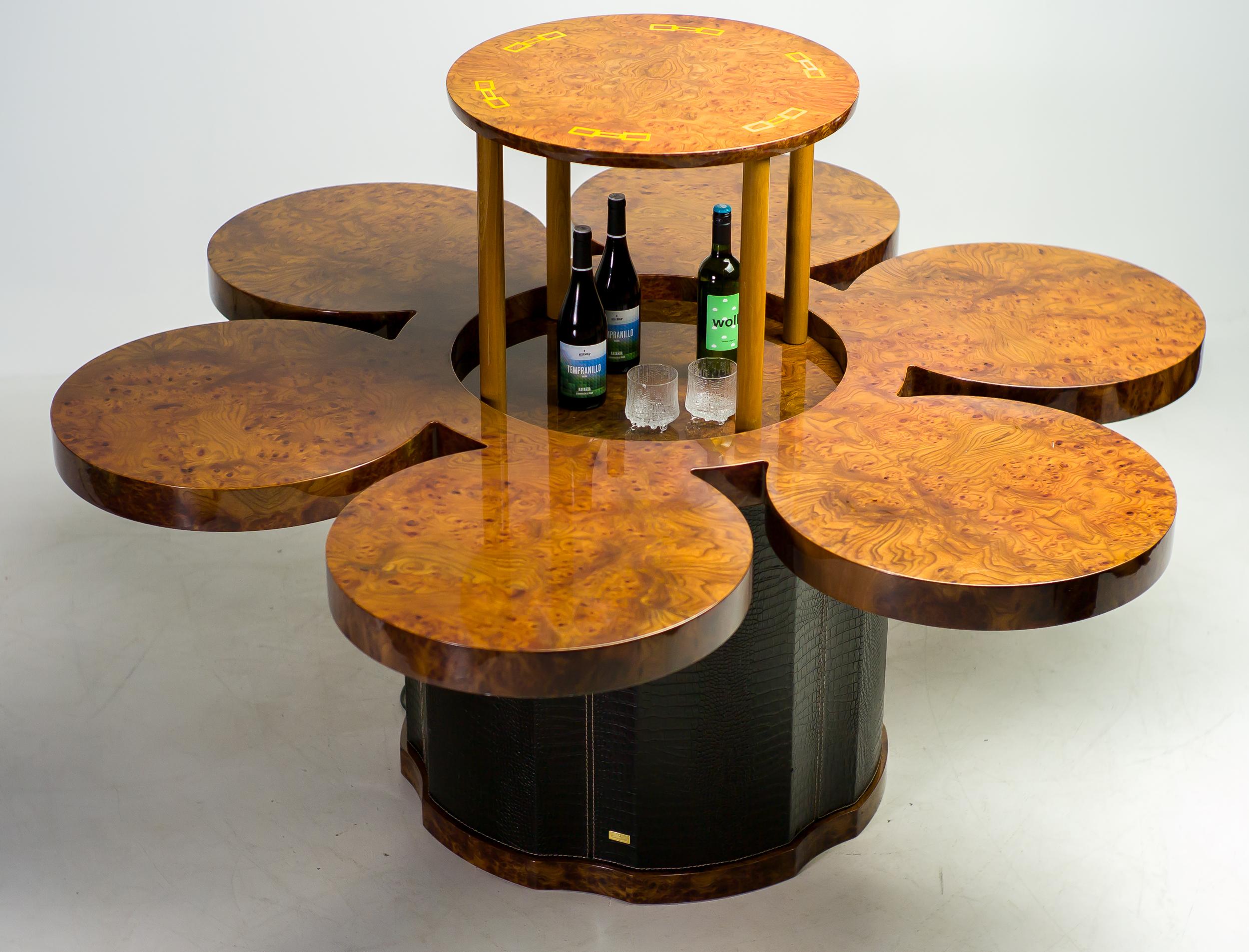 One-off dining table by luxury Italian design label Formitalia, with built-in electrical bar lift.
Leather clad base, burl walnut veneered top with yellow inserts. Formitalia is renowned from their collaborations with Aston Martin and