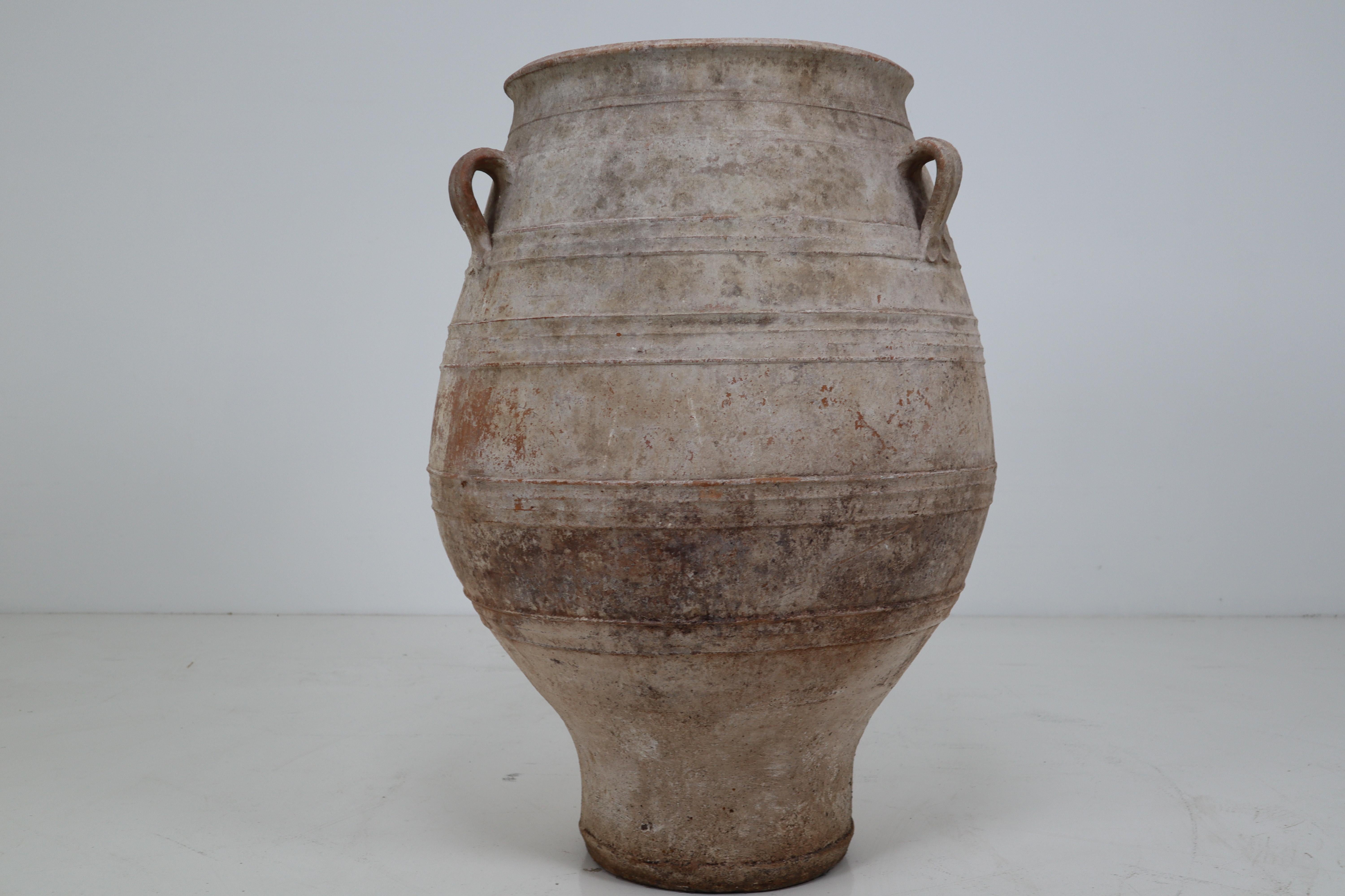 A large vintage three-handled painted terracotta urn from early-20th century Greece, with white finish and rounded belly. Picture this large 1900s urn in its former life, on a shaded terrace under an olive tree overlooking the Mediterranean Sea in