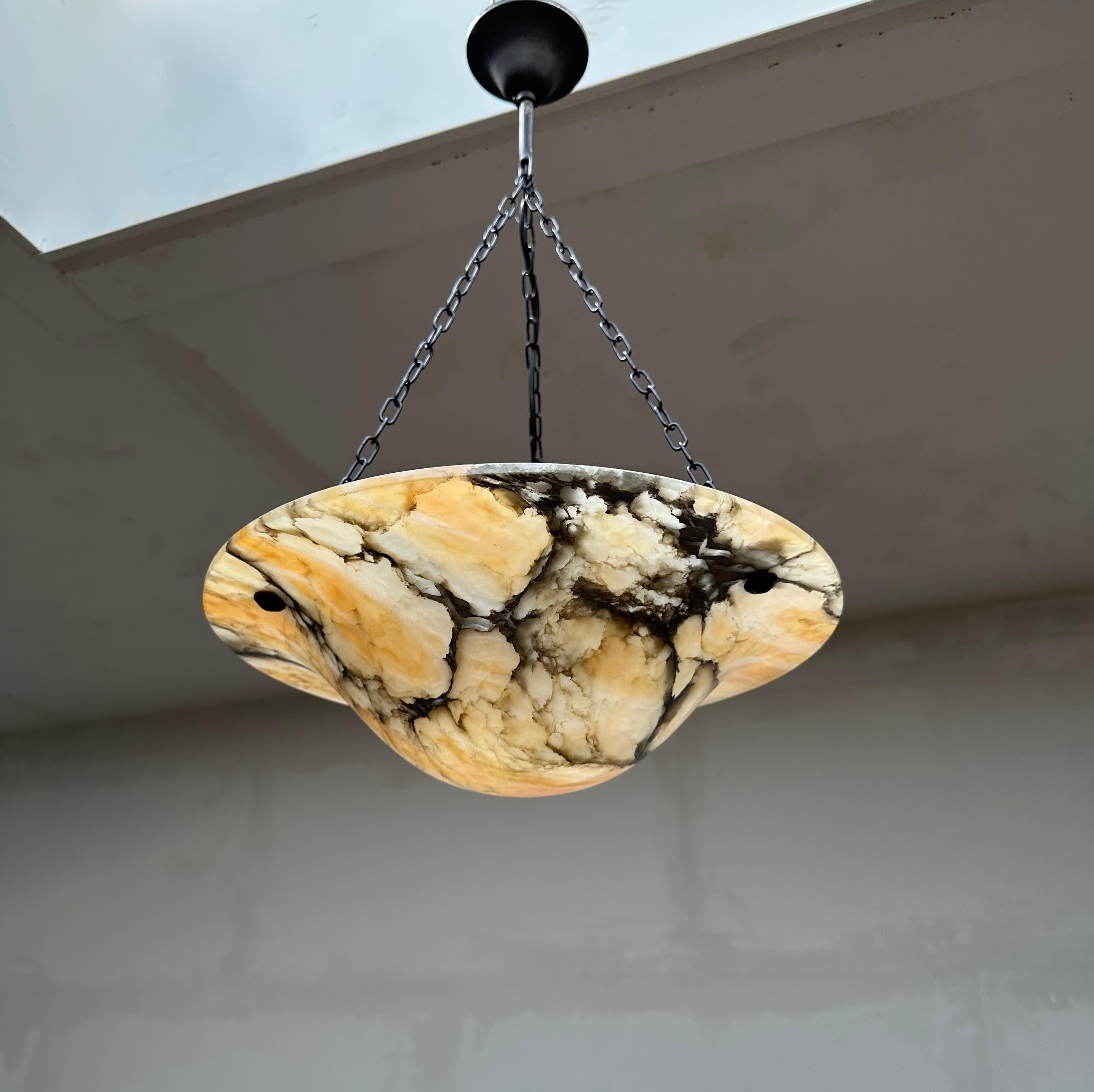Beautiful shape and amazing colors and patterns, alabaster pendant.

If you are looking for a unique and great quality antique light fixture to grace your living space then this beautifully designed and all-handcrafted alabaster chandelier could be