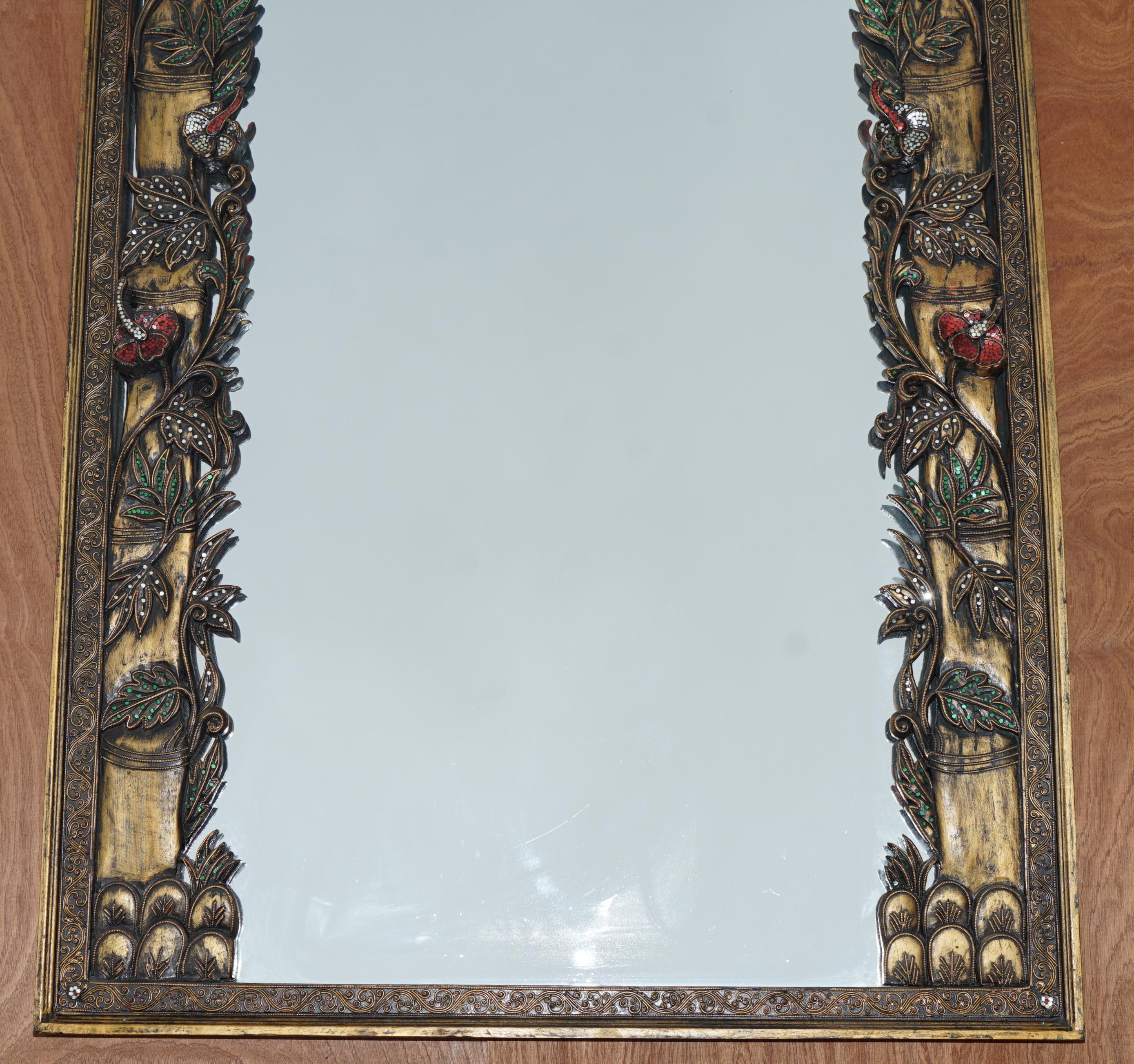 We are delighted to offer this very decorative full length mirror with birds of paradise in trees details

A super decorators piece, the frame has a depth you just don’t see often, its heavily carved and very intricate with a wonderful forest