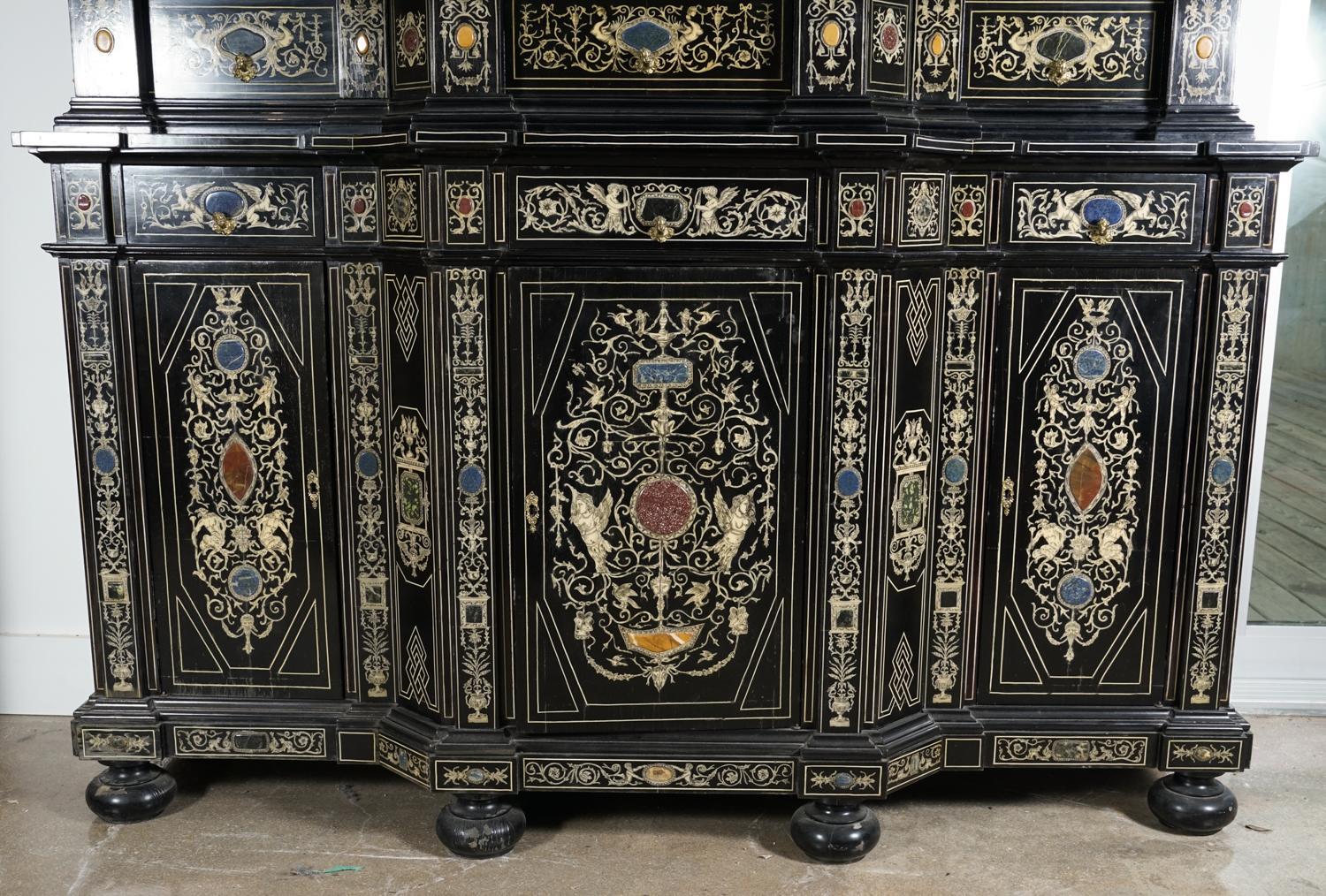 Extremely fine Italian Baroque ebonized wood, faux ivory, and hardstone cabinet, Florence, 20th century.

Decorated overall with Berainesque (light arabesques and playful grotesques) motifs including rinceaux, putti and mythical birds, and inlaid