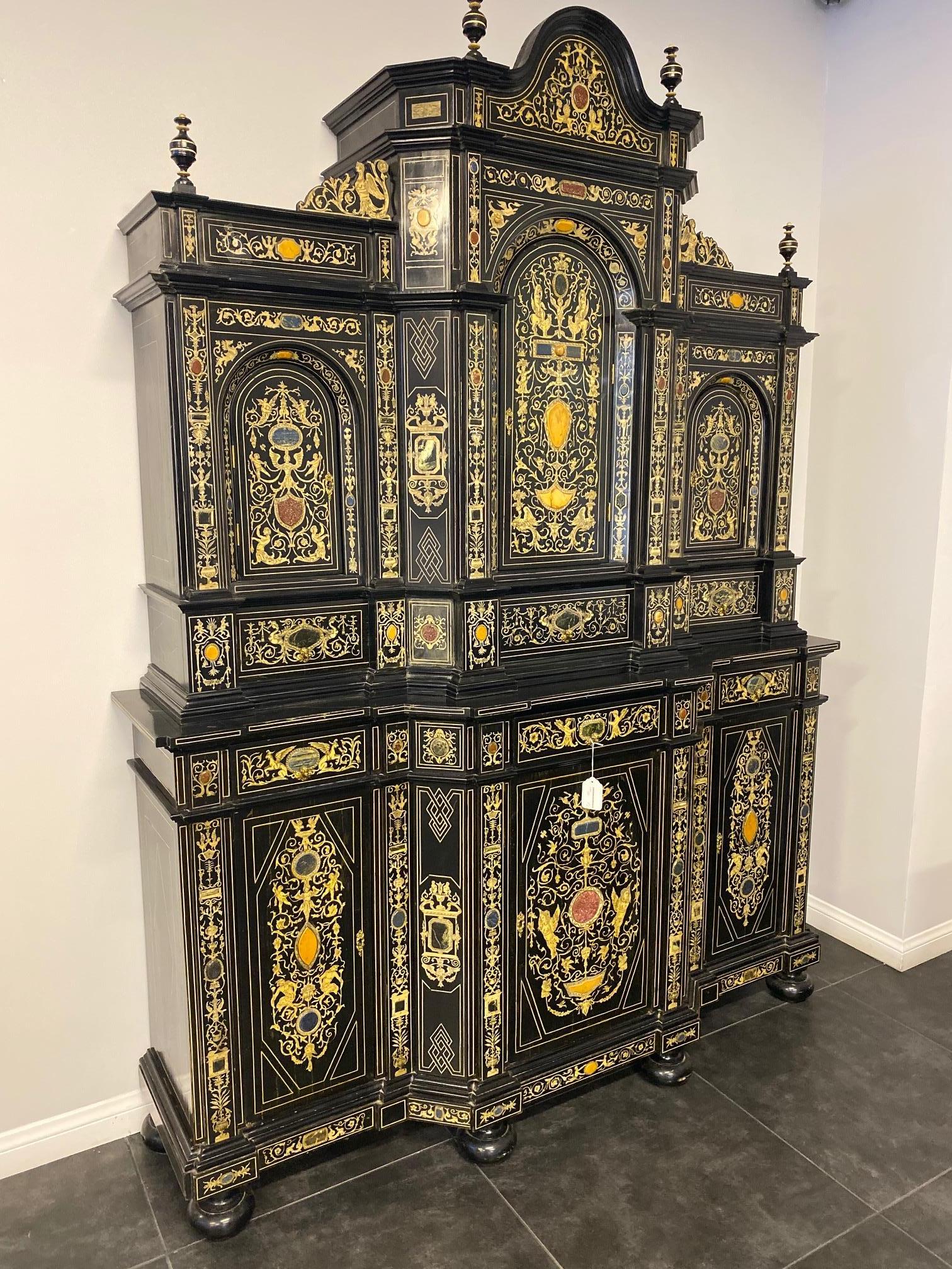 Extremely fine Italian baroque ebonized wood, faux ivory, and hardstone cabinet, Florence, 20th century.

Decorated overall with Berainesque (light arabesques and playful grotesques) motifs including rinceaux, putti and mythical birds, and inlaid