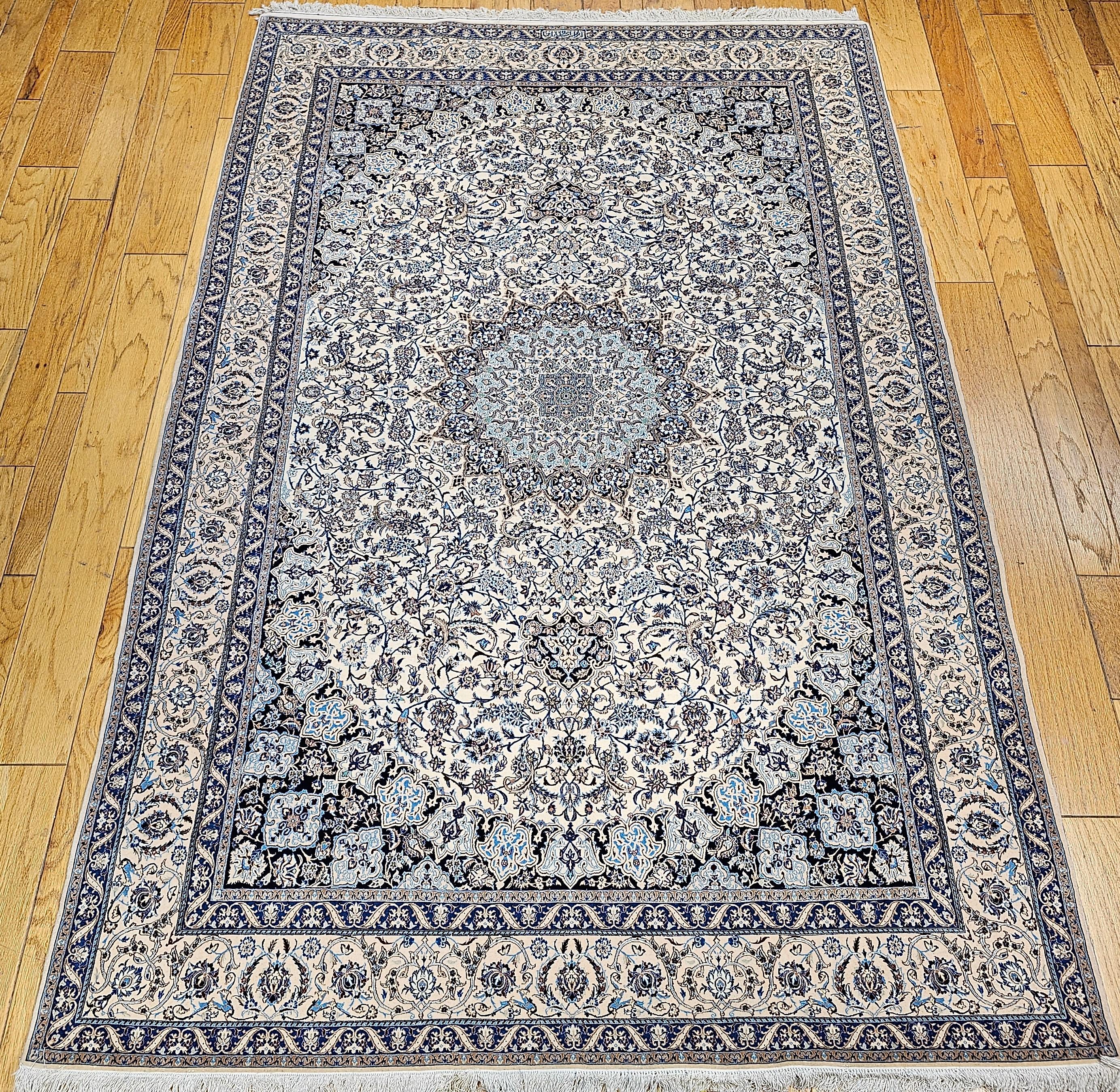  An extremely fine weave handwoven Nain area rug from the 4th quarter of the 1900s with a fine weave in ivory, pale blue.  This Nain has a beautiful floral design set in an ivory color field with a cream color border.  The Nain has one of the most