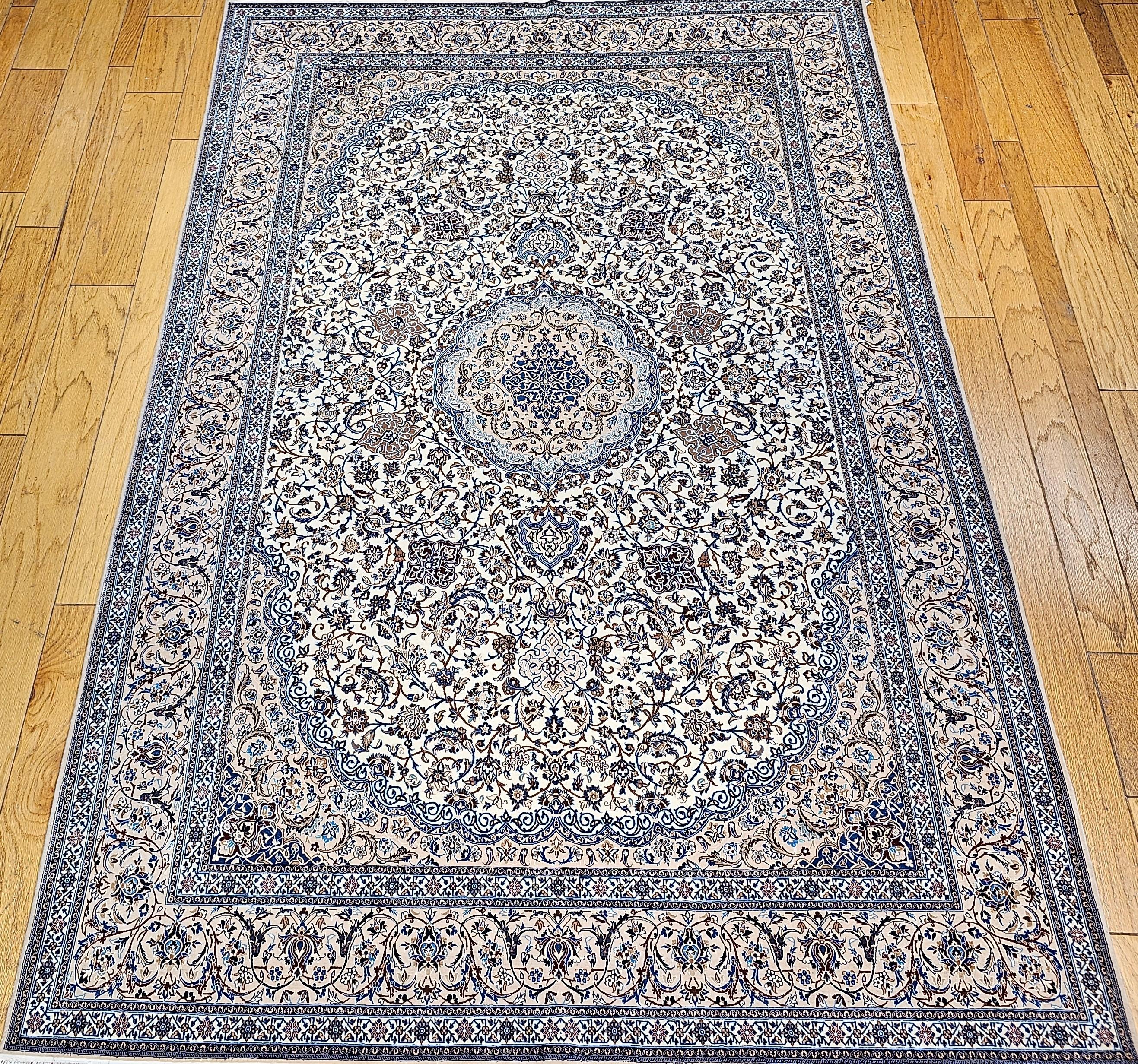 An extremely fine weave handwoven Nain area rug from the 4th quarter of the 1900s with a fine weave in ivory, pale blue.  This Nain has a beautiful floral design set in an ivory color field with a cream color border.  The design colors in the field