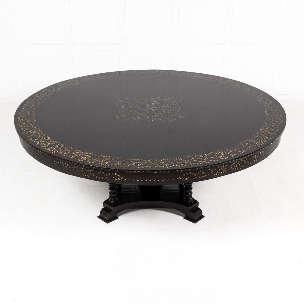 An Extremely Large and Important Ebonised and Ivory Inlaid Centre Table. Circa 1900.

The table with quadripartite platform base and five turned columns supporting the top, one central column and four smaller columns to the corners of the platform.