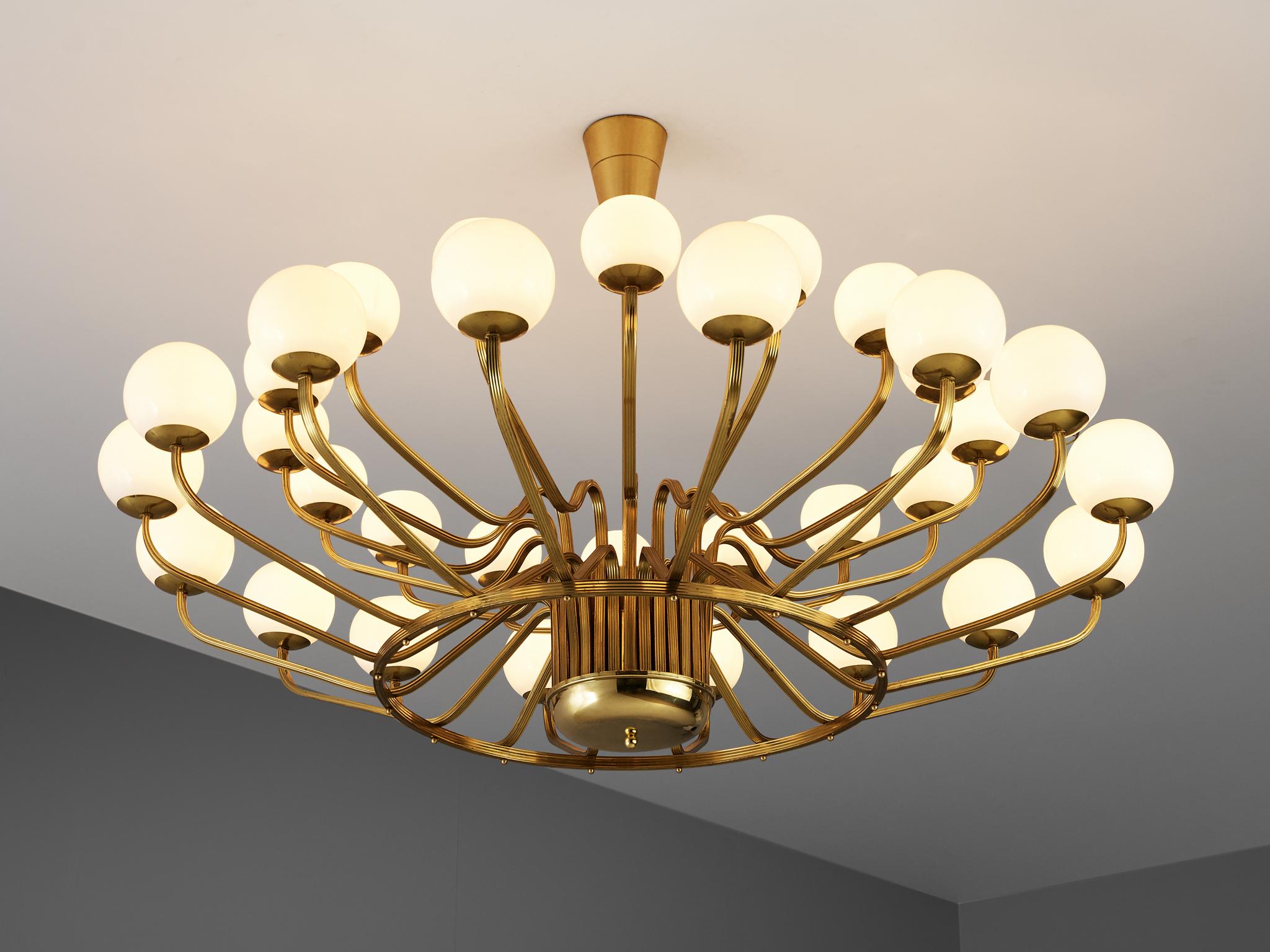 Chandelier, in brass and glass, European, 1970s.

Large chandelier with brass fixture and art-glass. The chandelier with brass frame consist of two rows sixteen lights, formed in a circle, with glass shades. The pleasant light it spreads is very