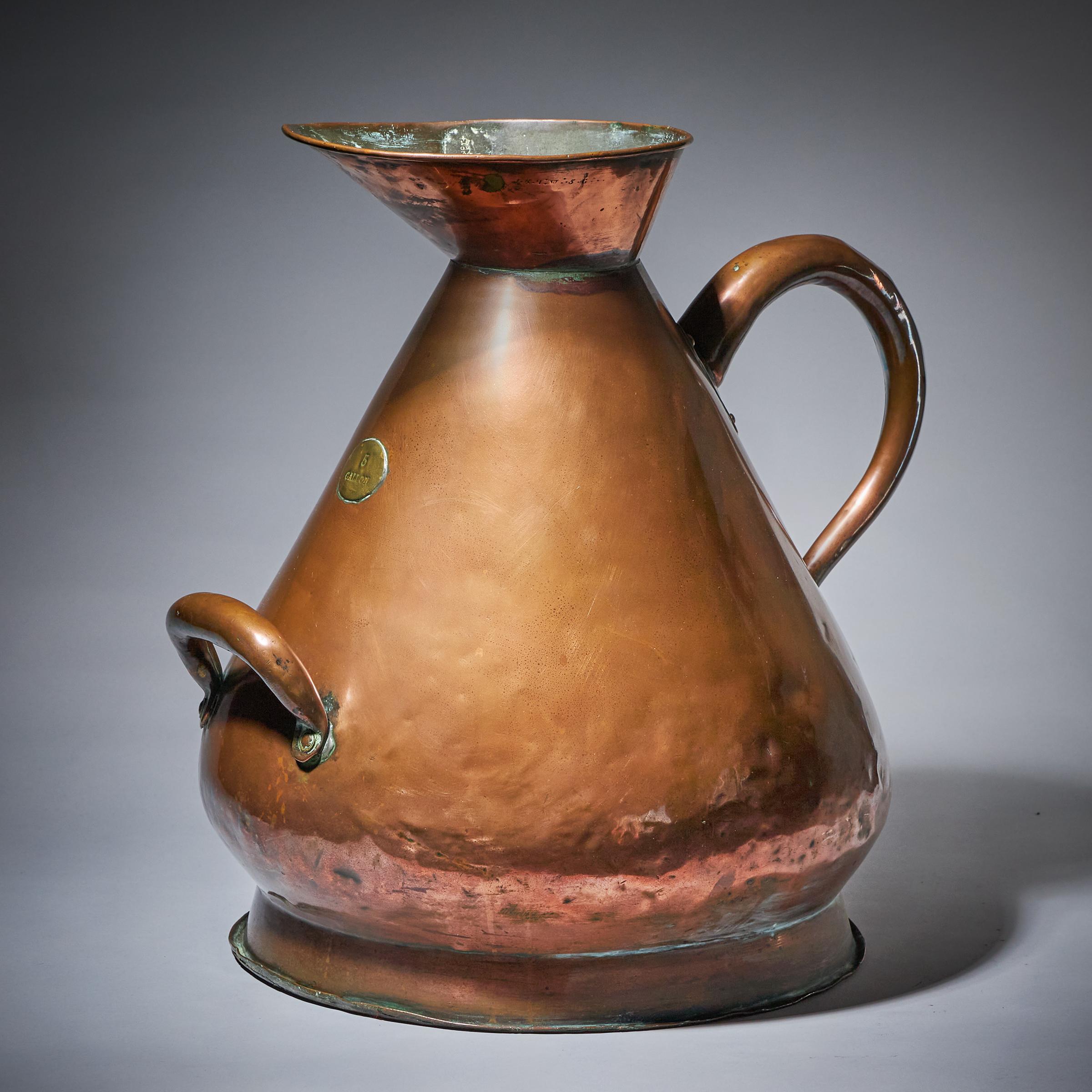 A fabulous and large scale country house 5 gallon hammered copper milk jug or pitcher. 

Due to the large scale, this jug/pitcher would make a fabulous centrepiece on a dresser/console table or simply placed on the floor and adorned.

Provenance