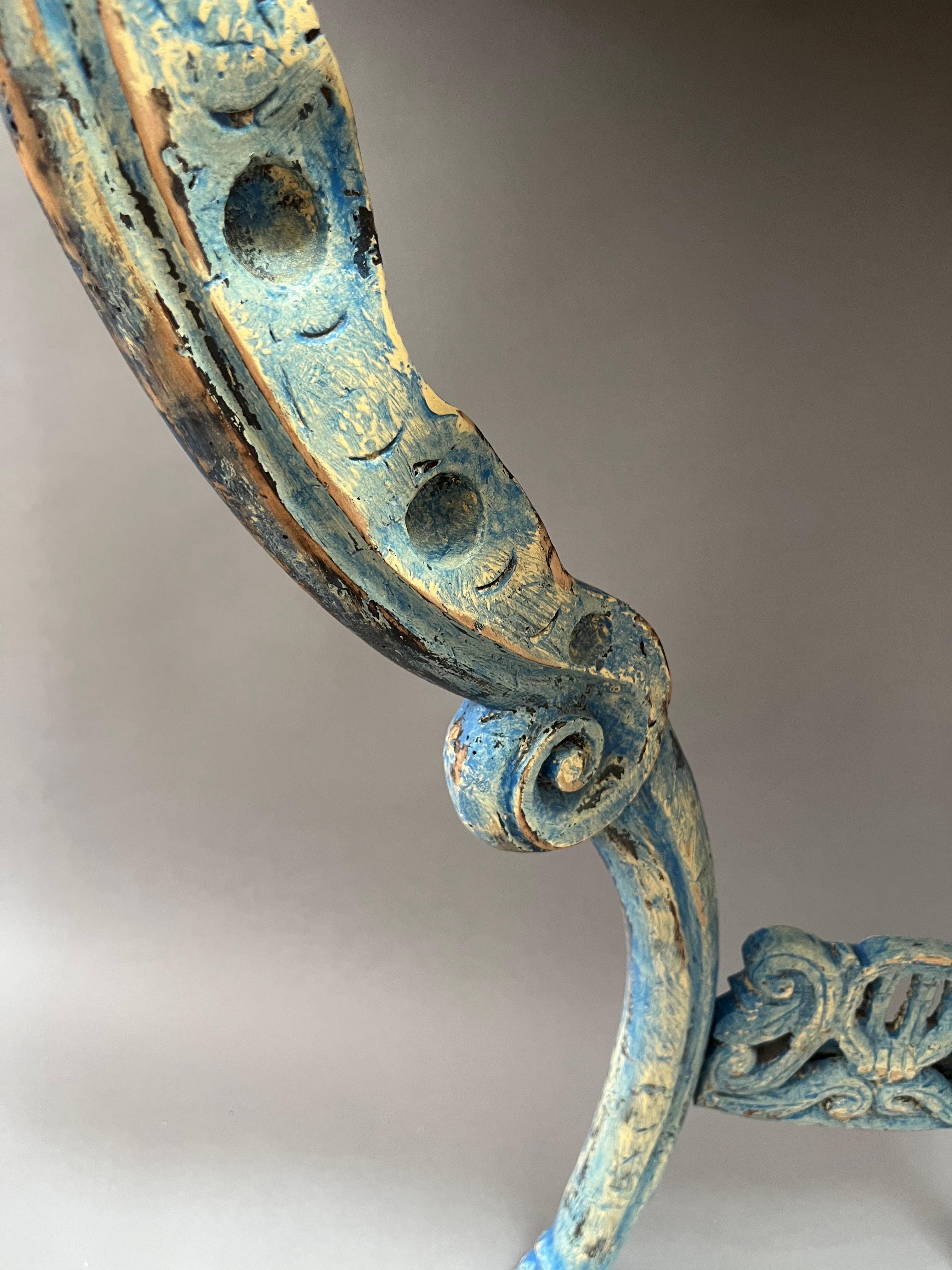 Extraordinary carved foliate and feather decoration to pierced apron with boldly shaped cabriole legs, acanthus carved knees terminating in hoof feet.- Made of circassian walnut with interesting old blue painted finish. Normandy, circa 1750.