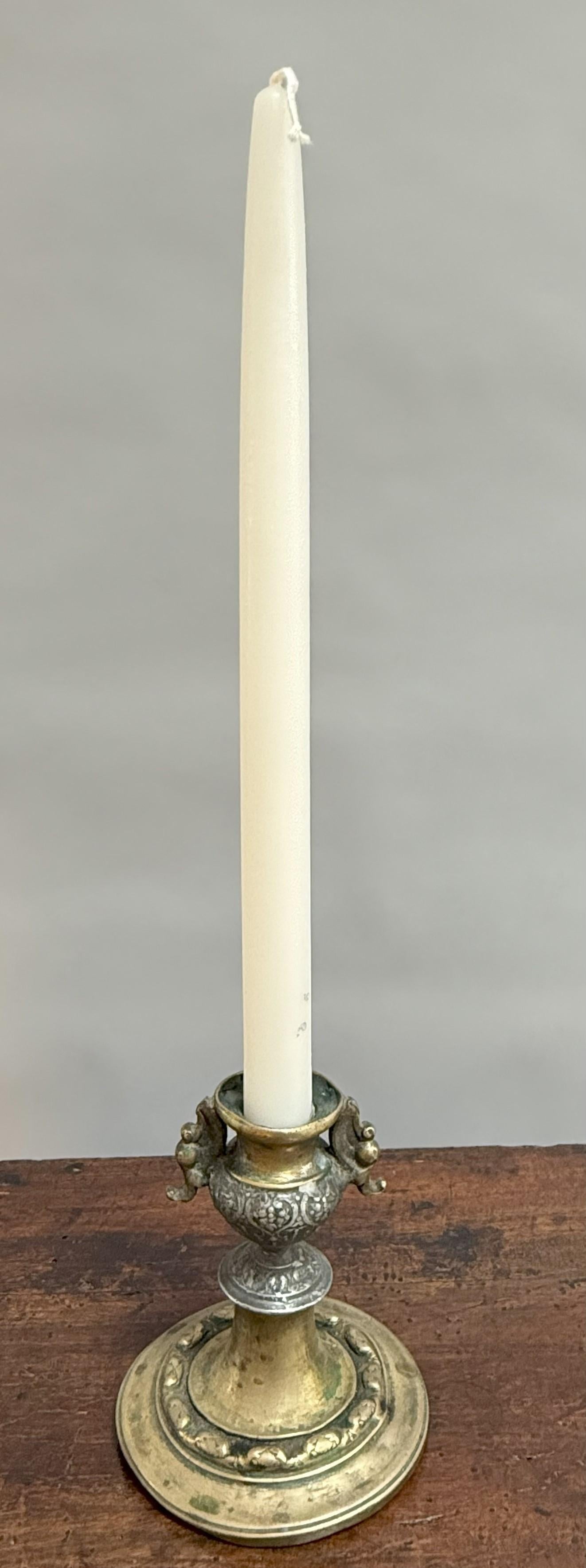 An extraordinary survivor of the Spanish Colonial era, this rare 18th-century candlestick radiates both history and refinement! Crafted in Peru circa 1750, it is cast in richly patinated brass and embellished with silver highlights, lending a
