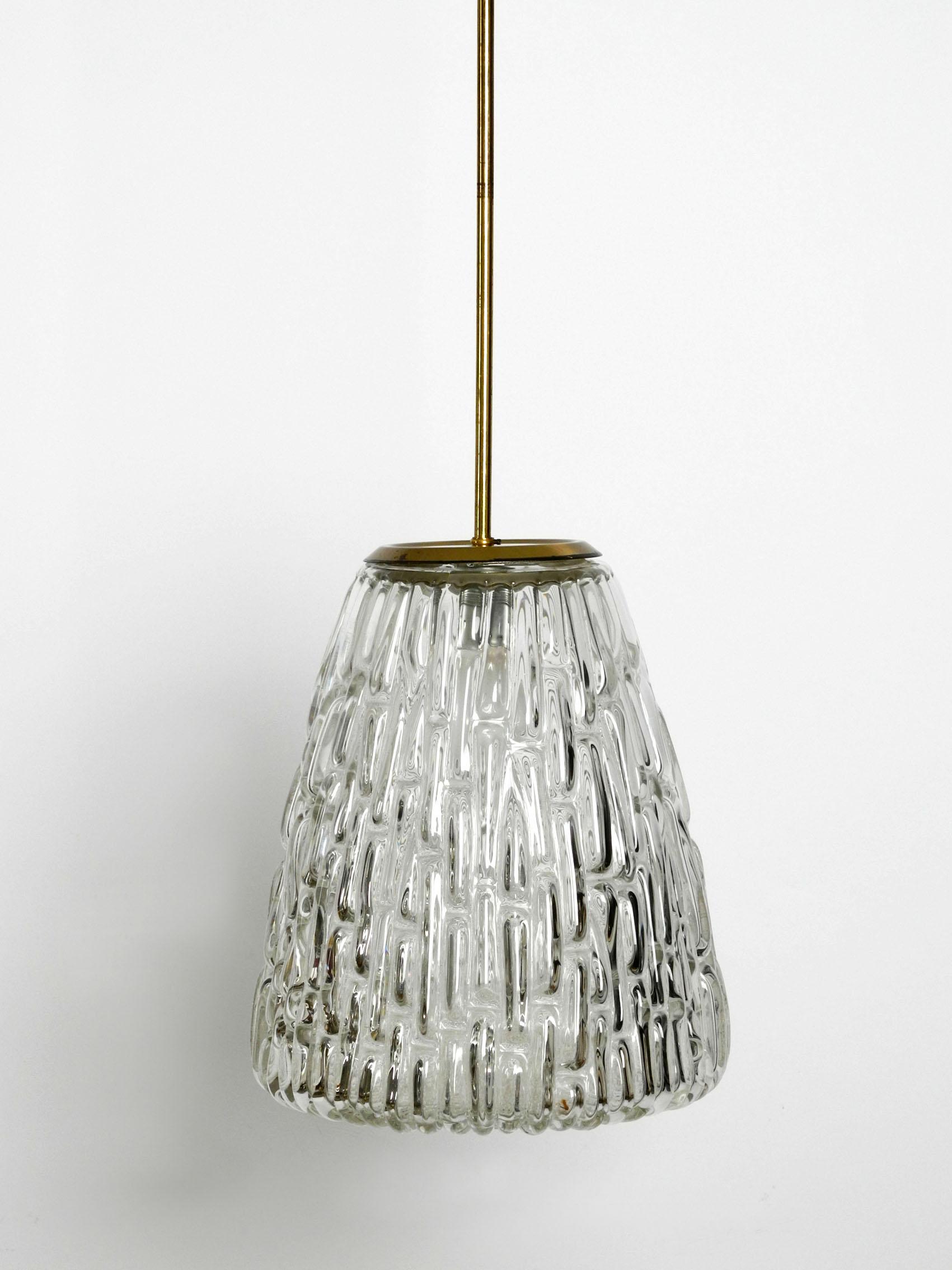 Extremely rare very heavy midcentury glass pendant lamp by Rupert Nikoll. Made in Vienna Austria.
Beautiful high-quality closed glass shade made of thick, very heavy clear glass with a abstract pattern.
Long rod and the canopy are made of