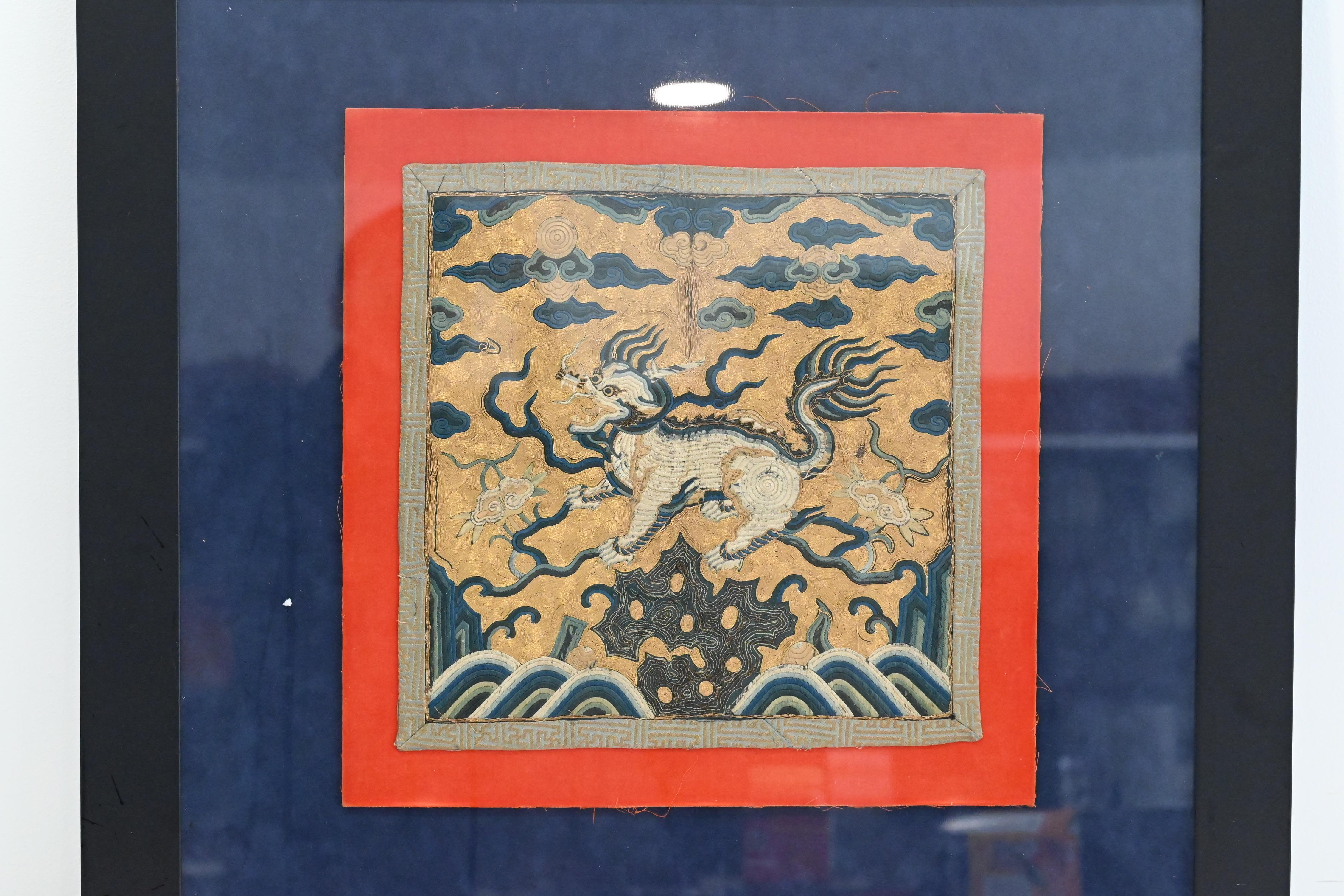 This antique Chinese silk military rank badge from the Kangxi period features a Xiezhi, a mythical creature known for its ability to distinguish between good and evil. The intricate details on the badge reflect the importance of rank and status