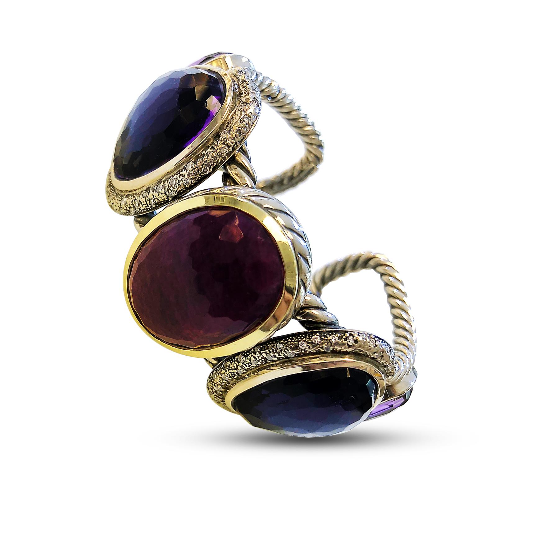 Like every David Yurman's product, this is 'founded by Artists and rooted in artistry'. This rare Buckle bangle comes with every artistic imagery you could ever think about. It features a round cut 28mm by 22mm Ruby and 4 round cut 18mm by 14mm and
