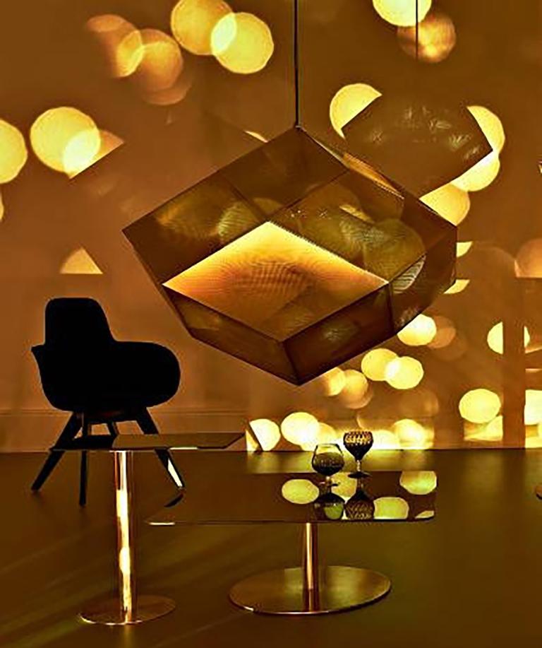 These extremely rare etch pendants by Tom Dixon are made from brass sheets, on which the pattern of holes is first photo-etched, then dissolved with acid. The brass is lacquered to prevent oxidization. These three particular pieces were never put