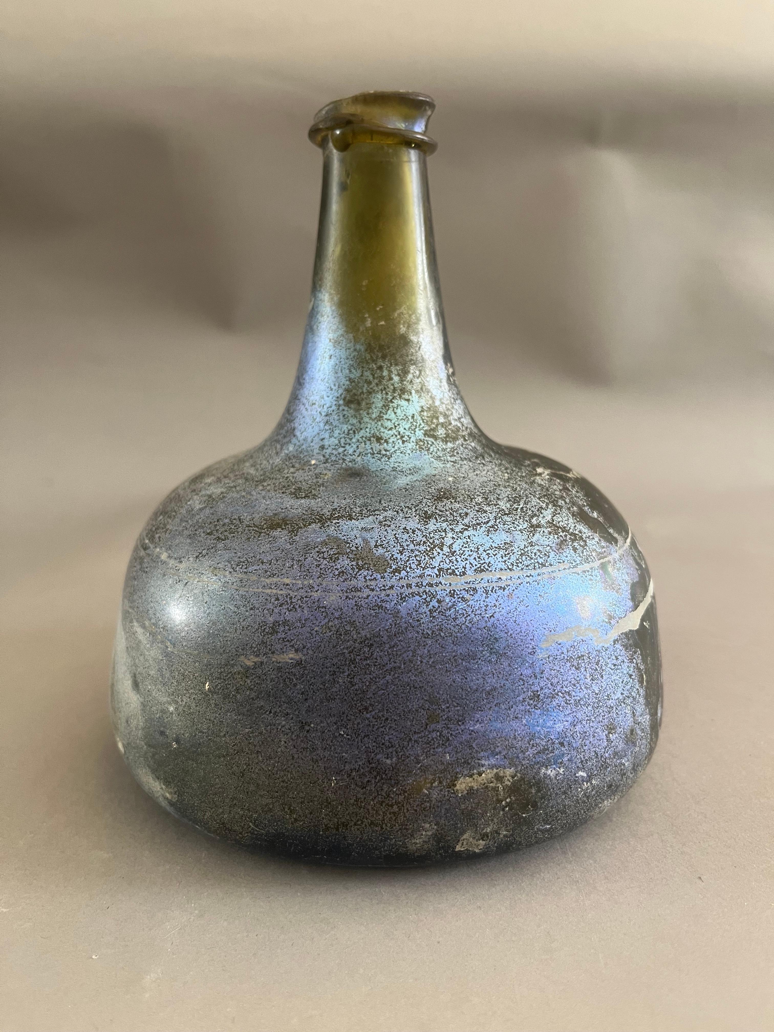 Extremely Rare French 17th Century Brandy Bottle. Hand-blown with an extraordinary effervescent patina. Found on a shipwreck in the English Channel. Made in France circa 1650.

An extraordinary and evocative artifact, this 17th-century French brandy