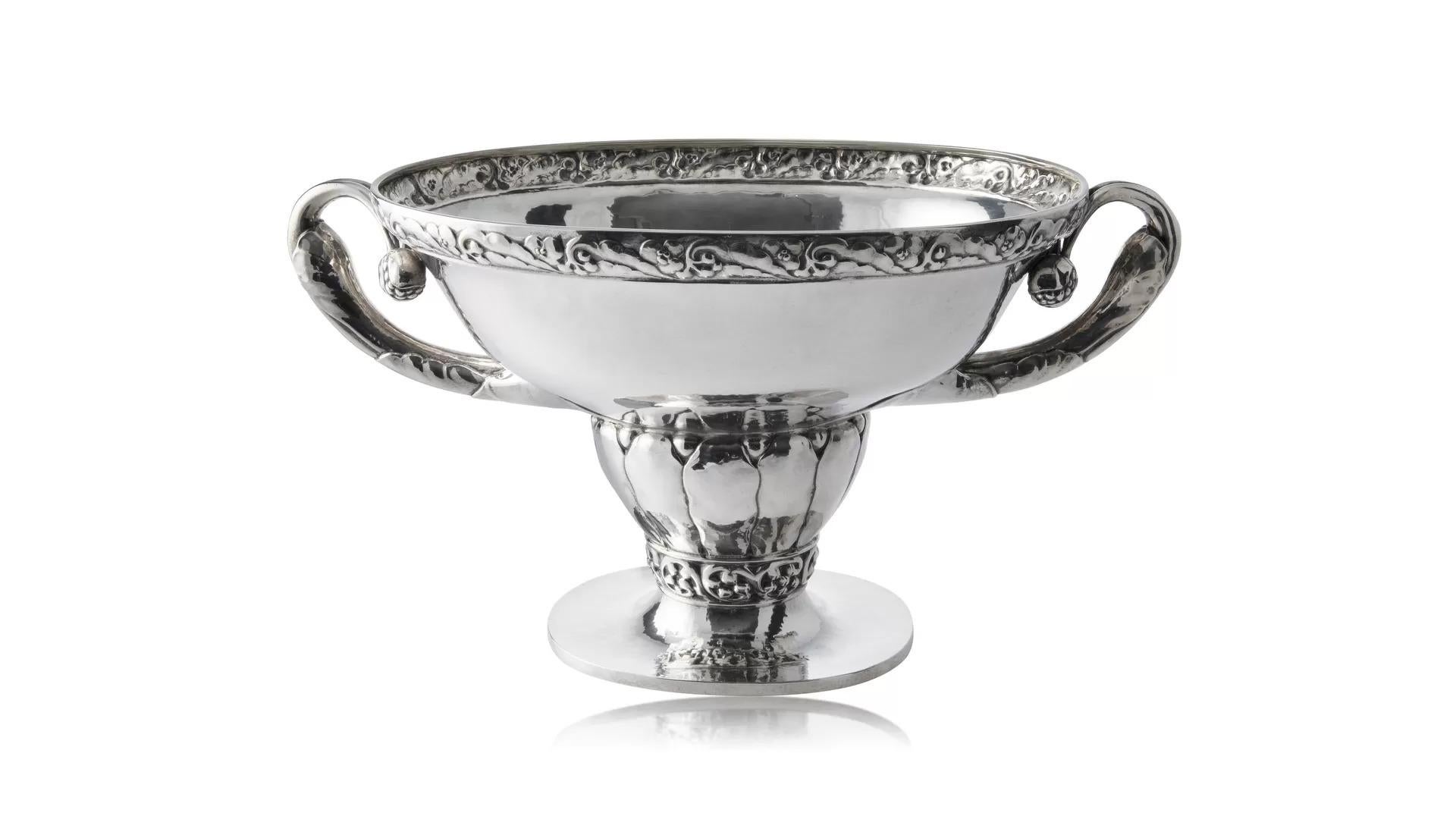 A Georg Jensen large silver Jardinière #165 designed by Georg Jensen in 1916. An early and rare item, one of the very first pieces produced in this design.  The jardinière features a large oval basin adorned with intricate floral borders, showcasing