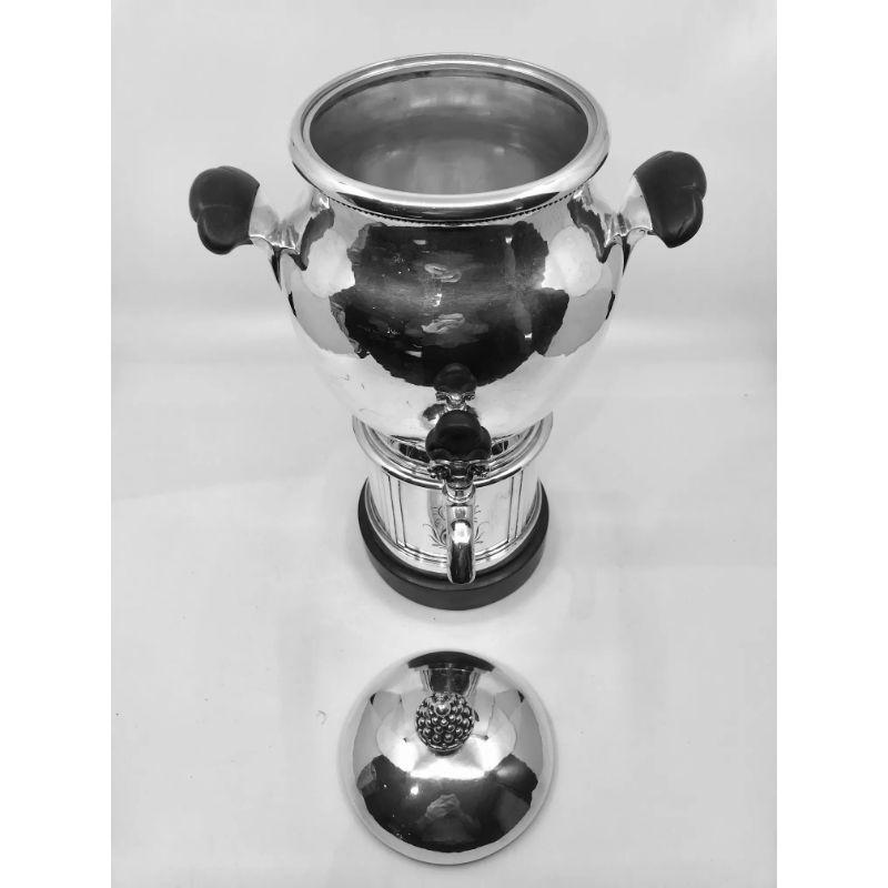 A rare signed and electrified Georg Jensen Danish sterling silver coffee urn with ebony handles, design #32 by Georg Jensen from circa 1913. The pedestal base with hand chased panels of flowers, the cover with berry-cluster finial. The tap turns, to