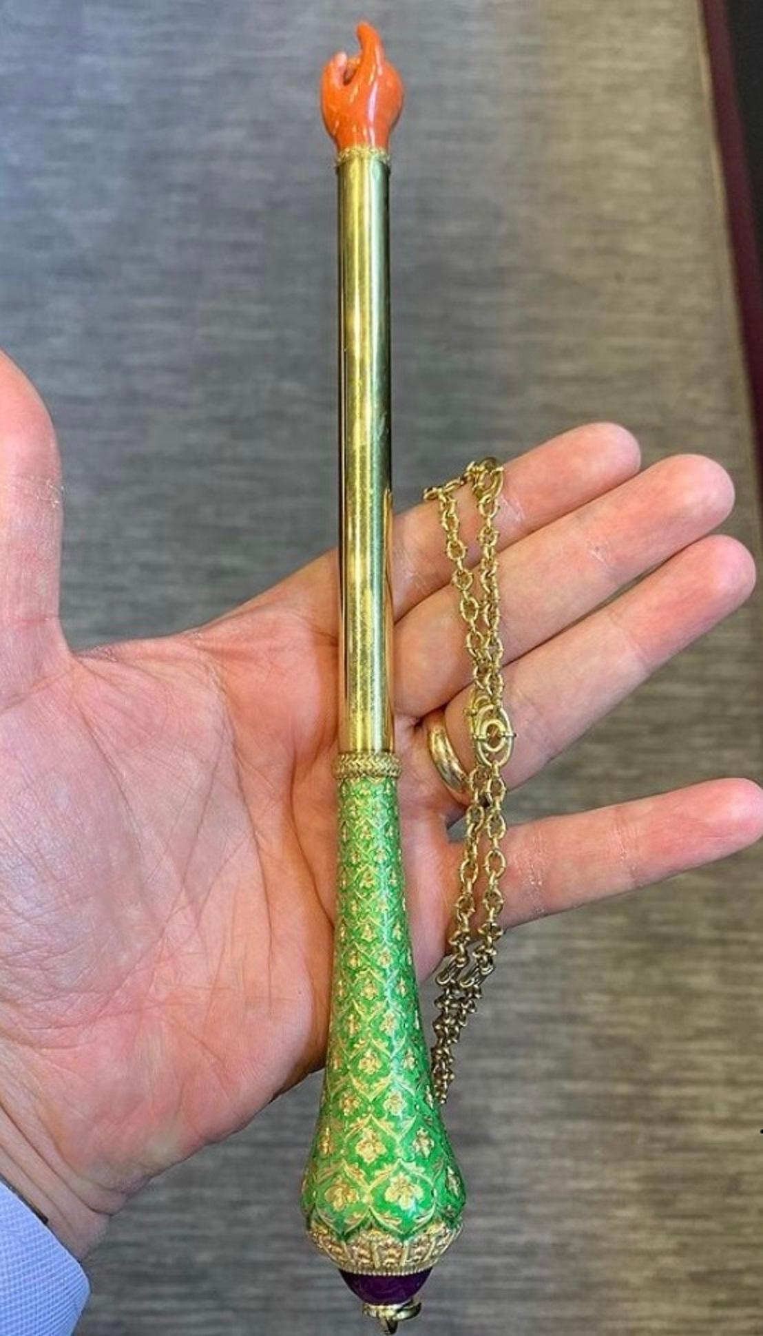 Gold & Enamel Torah Pointer
Green enamel decoration, cabochon ruby at the tip & a carved coral hand. 
Italian made Circa 1950 
Measurements: 9.5