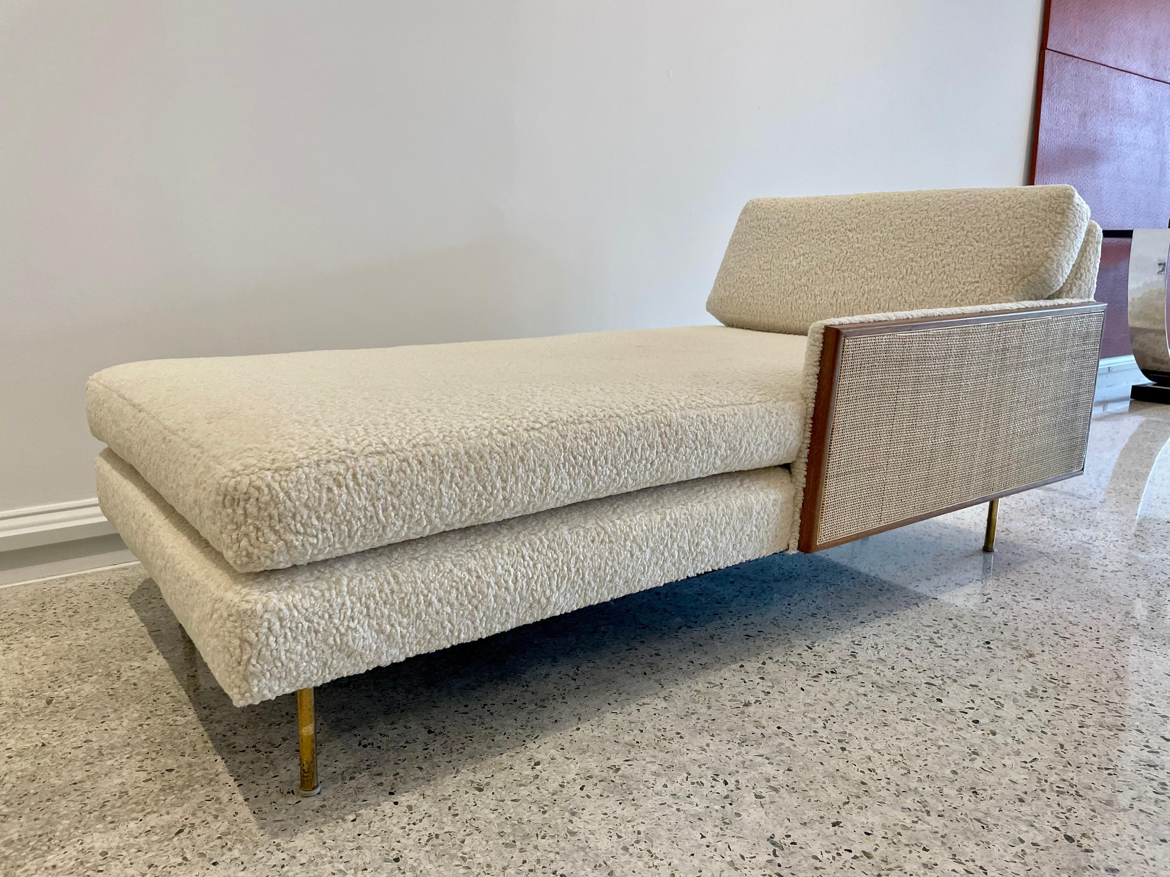 Nubby boucle fabric in natural tone. Fairly clean and lightly used condition. A couple of spots that are minimal. Walnut trimmed cane panel to one side and original brass legs.
