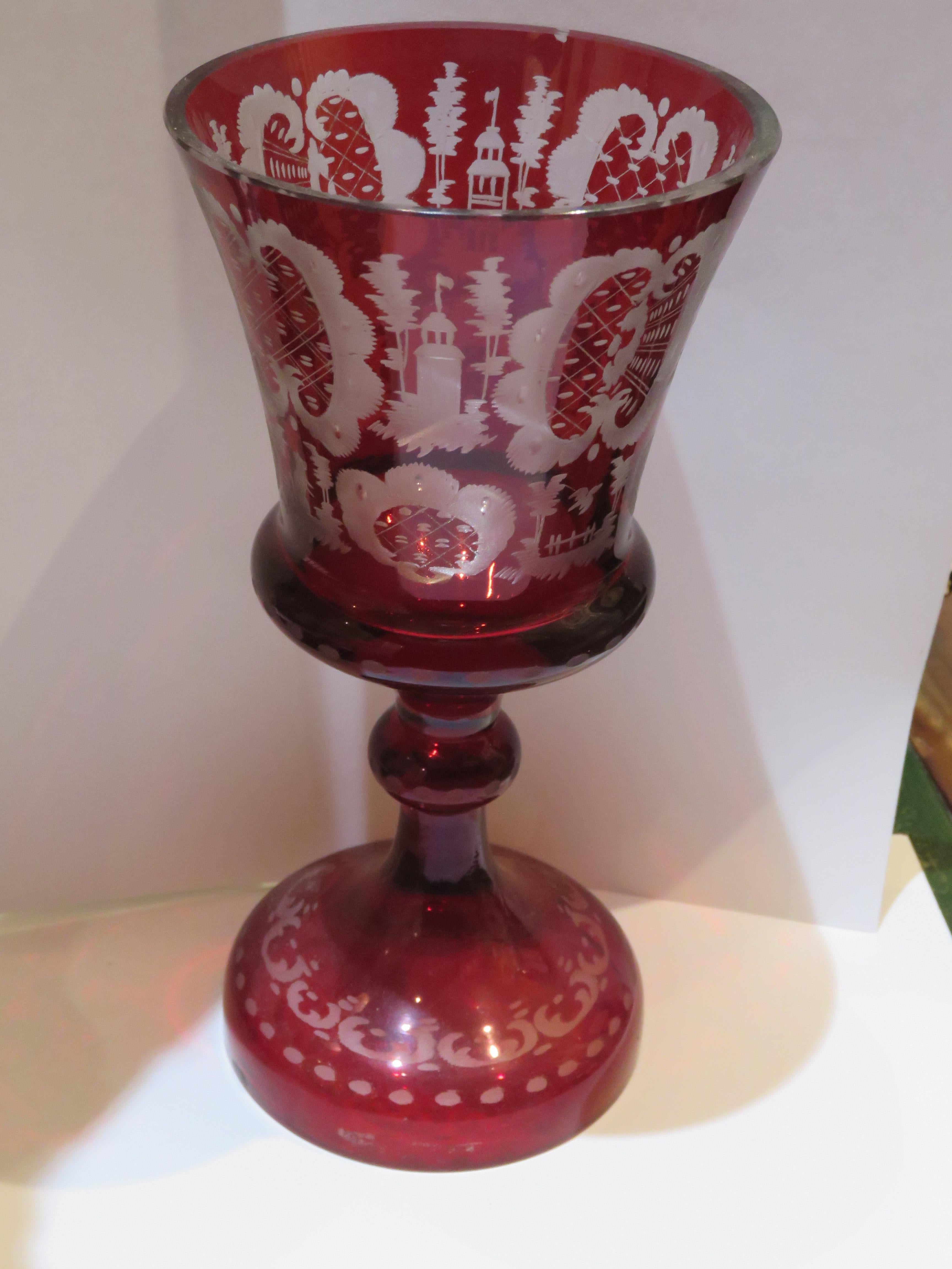 The Following Item we are Offering is A Magnificent Rare 19th Century Bohemian Etched Glass Goblet. Cranberry Red to Clear Glass Goblet has scrolled Etchings throughout of Animals, Trees, and  Monuments in a Nature Landscape! Originally Priced at