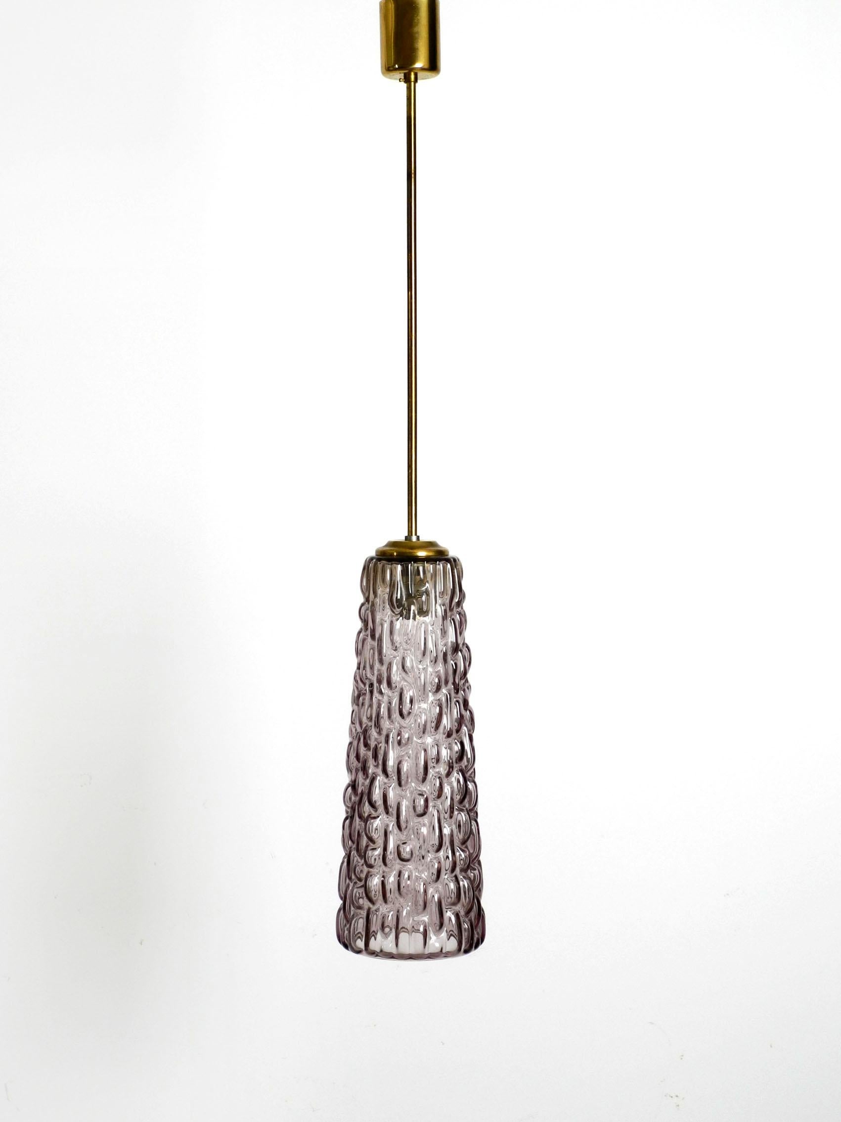 Extremely rare heavy long midcentury glass pendant lamp by Rupert Nikoll. Made in Vienna Austria.
Beautiful high quality bottom closed glass shade made of thick heavy glass in light purple- lilac with an abstract pattern. Long rod and canopy are